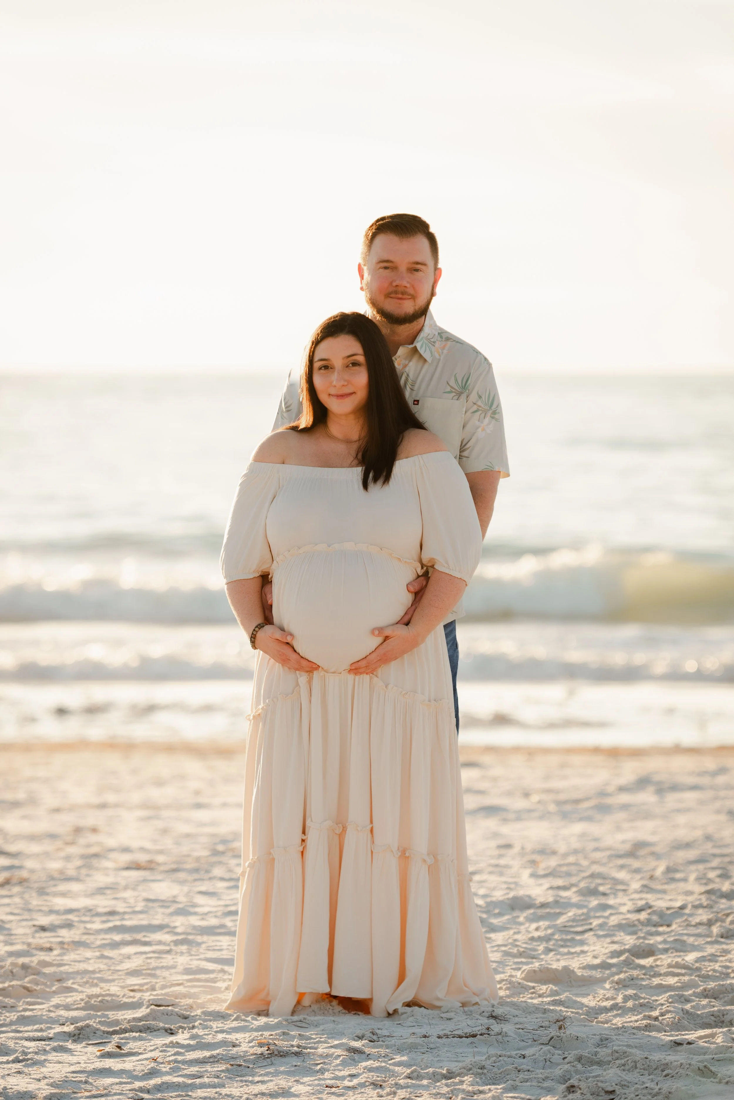 Couple standing together on the beach, maternity photos Fort De Soto Park