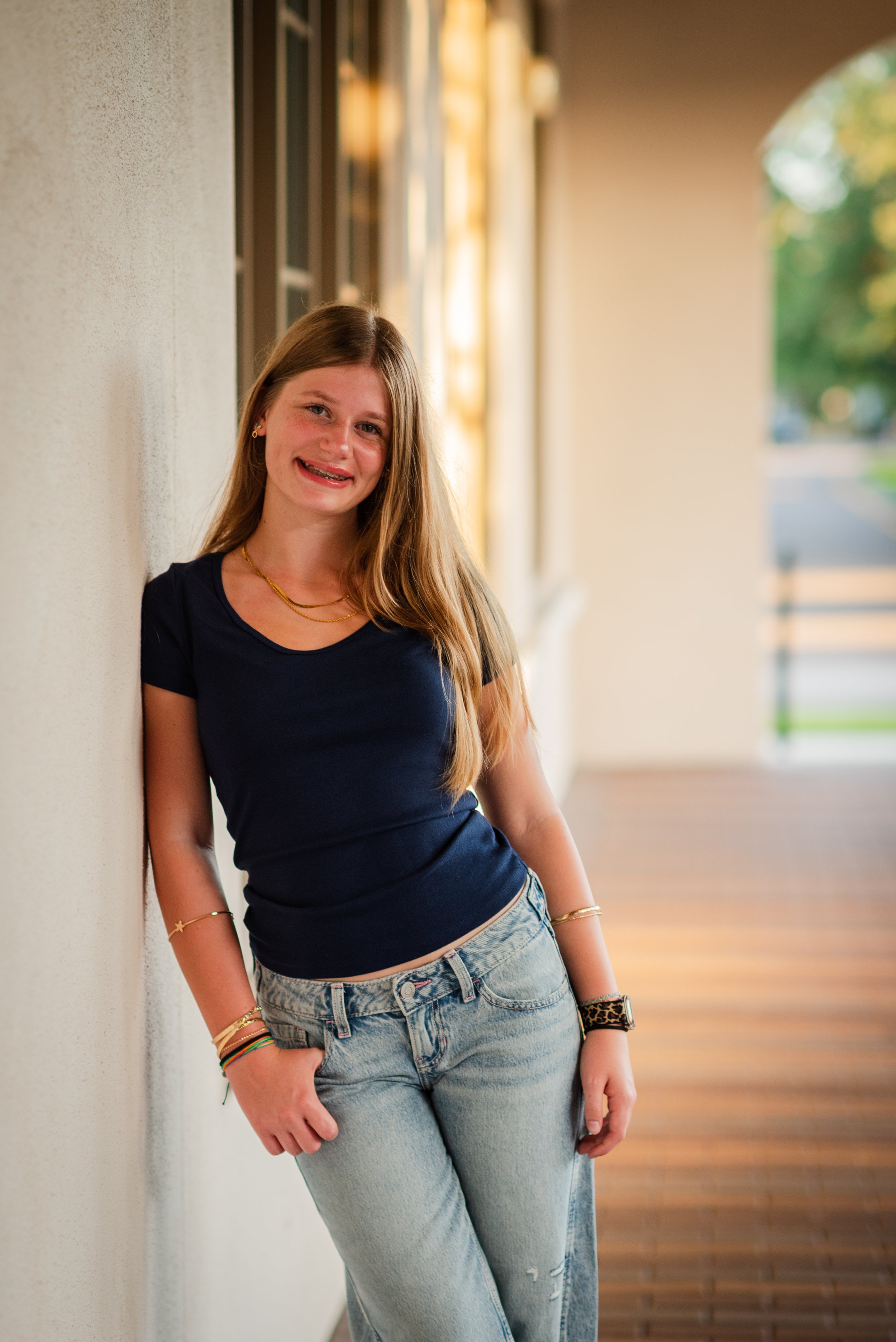 Teen girl leaning against wall at Starling Clubhouse, FishHawk Ranch