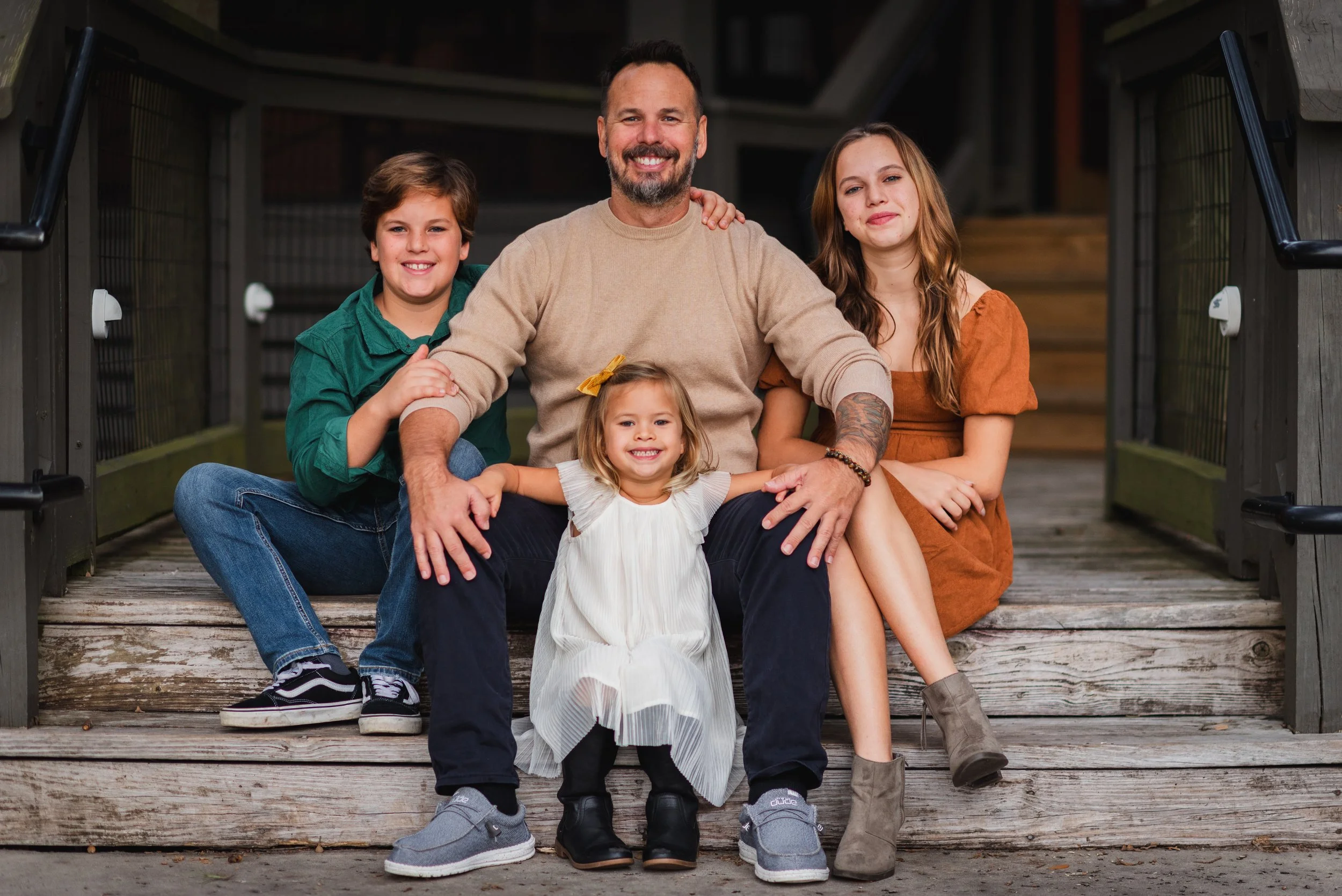 Father with son and teenage daughter on porch steps, FishHawk