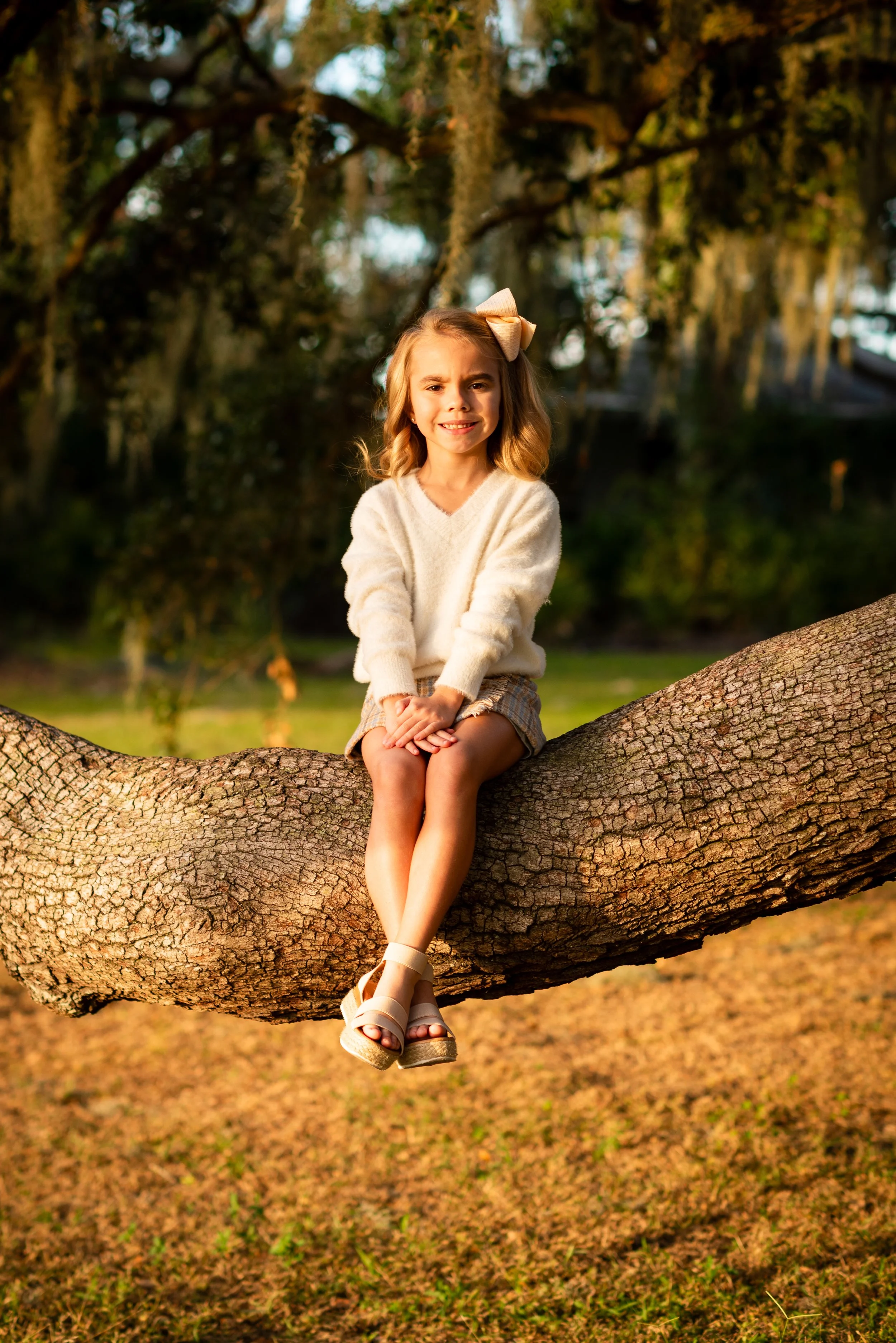 Young girl sitting on a tree branch at the Lake House, FishHawk