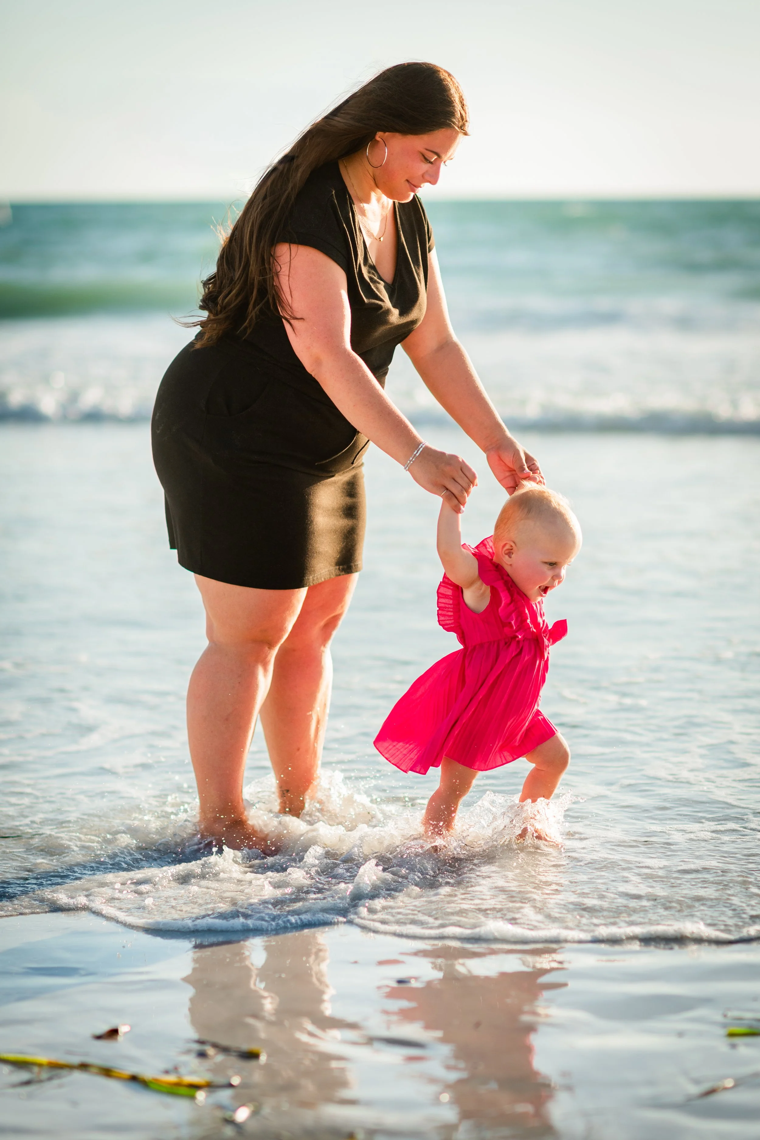 Mother and baby playing in the surf at Coquina Beach, Anna Maria Island