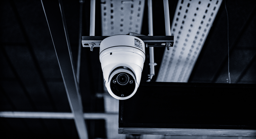 A security camera mounted on a ceiling in an indoor setting