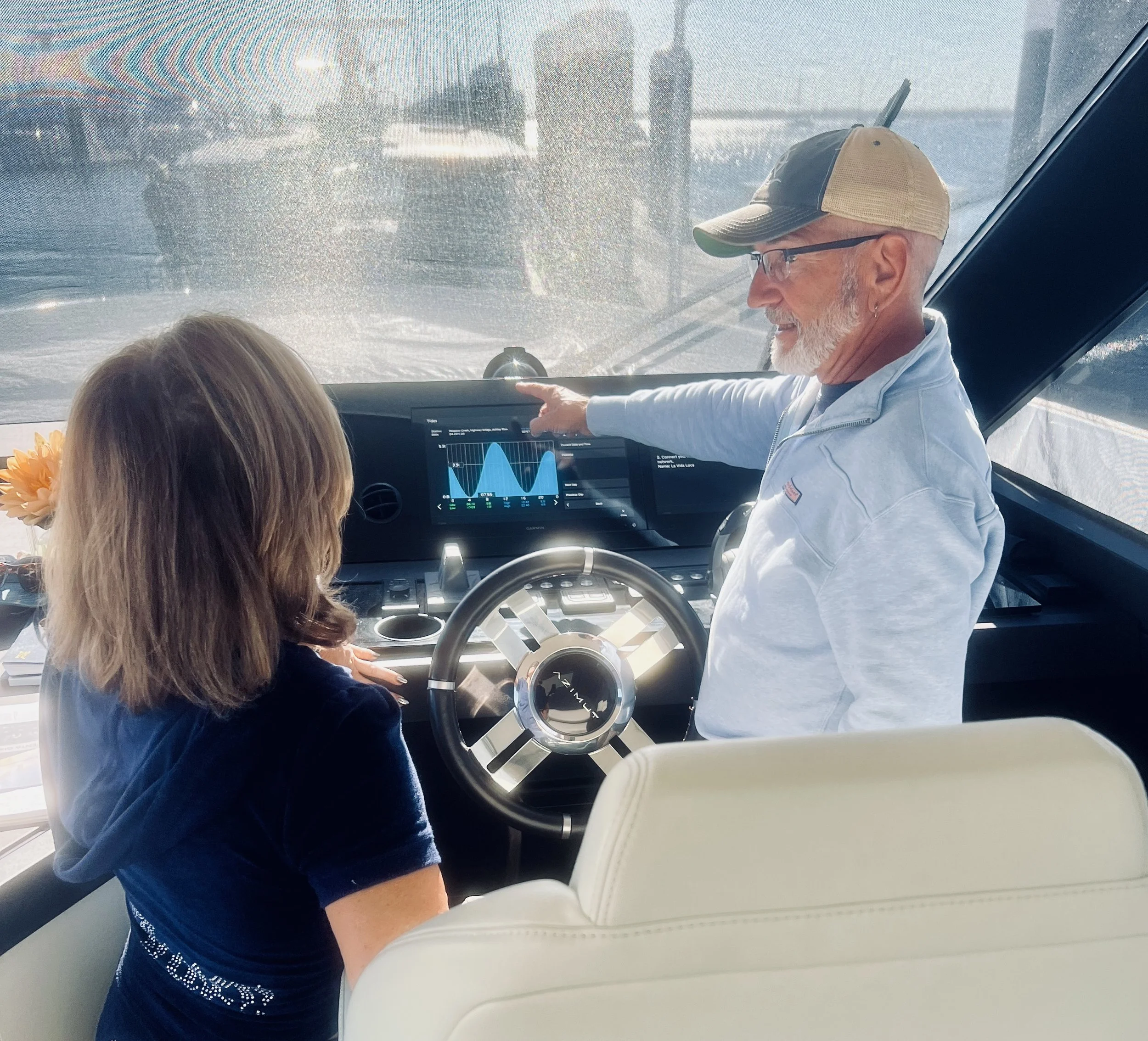 Licensed captain explaining vessel navigation electronics during private on-water training