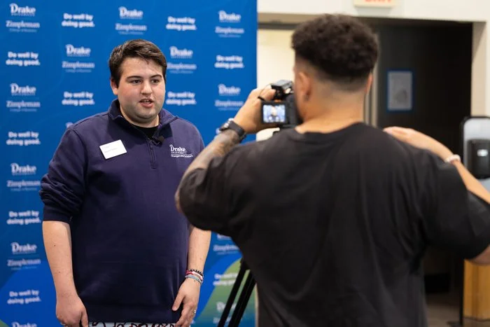 Emmy award-winning journalist, Nik Heftman, interviews a man during a video shoot at Drake University in Des Moines, Iowa.college in Iowa