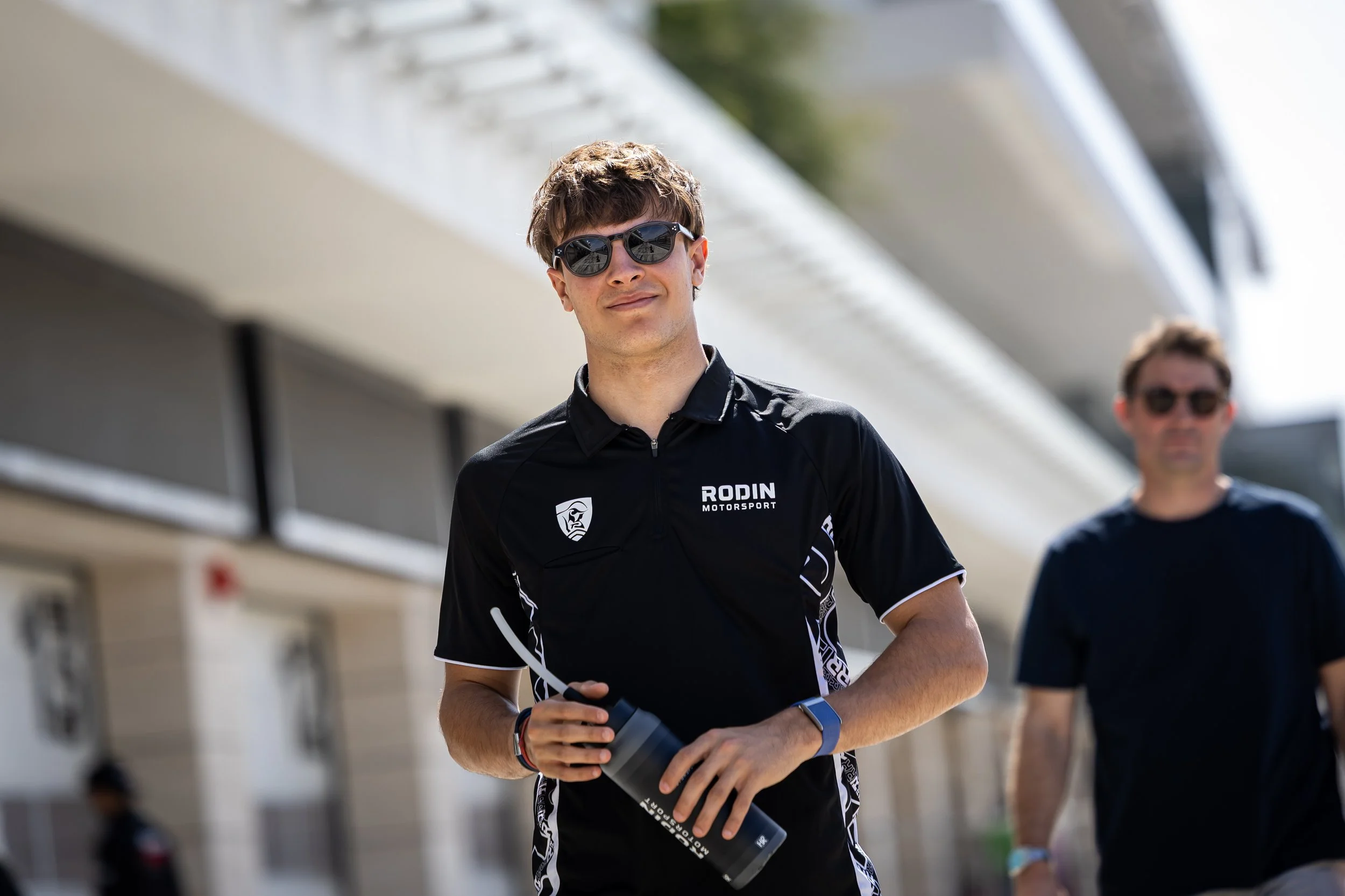 Rodin Race Driver Reza Seewooruthun walking through the pit lane at Lusail International Circuit