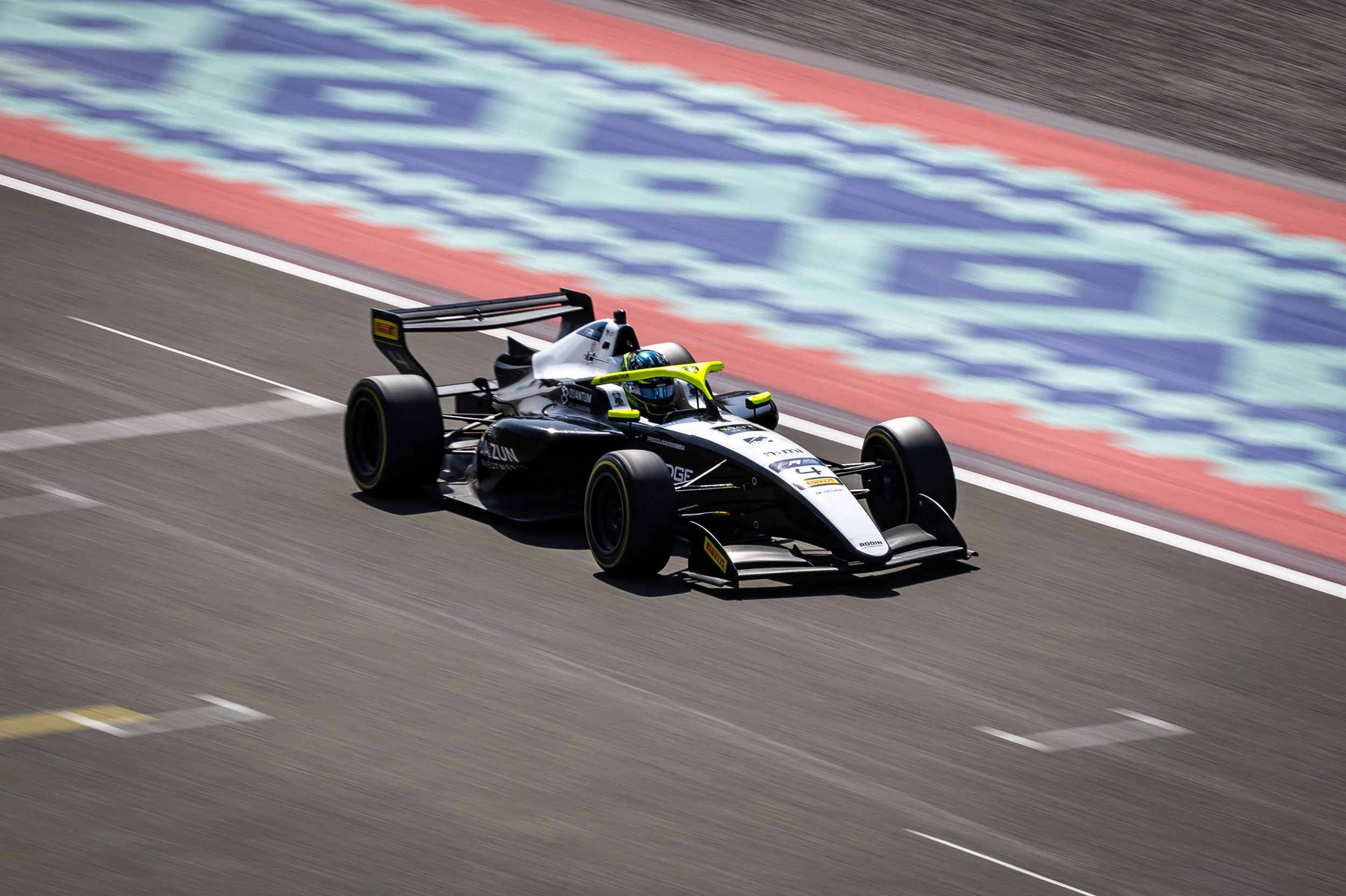 Reza Seewooruthun racing down the pit straight at Lusail International circuit for Rodin Motorsport in the Tatuus F3 T-326 chassis