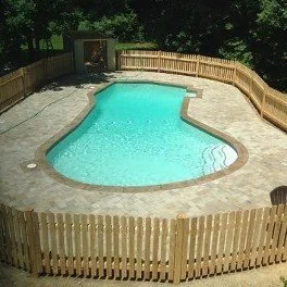 In ground pool patio and fence.