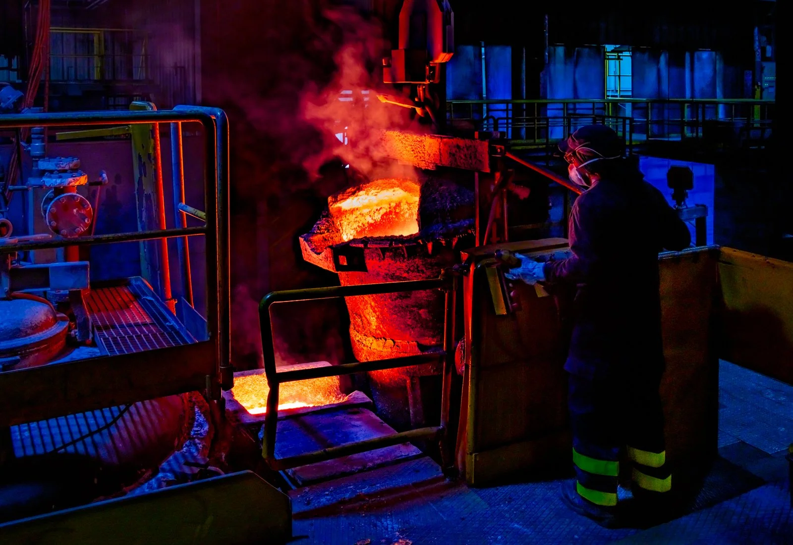 Escena de fundición industrial con metal caliente y maquinaria, atmósfera de proceso y materia.