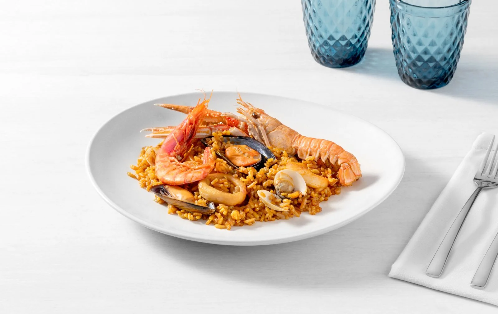 Emplatado de paella de marisco Silomar, fotografía de producto del mar para promoción.