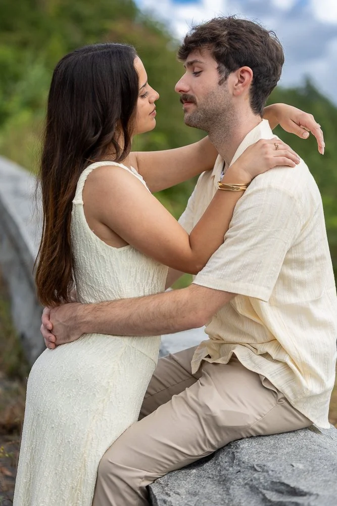Close portrait of an engaged couple embracing outdoors after a mountain proposal.