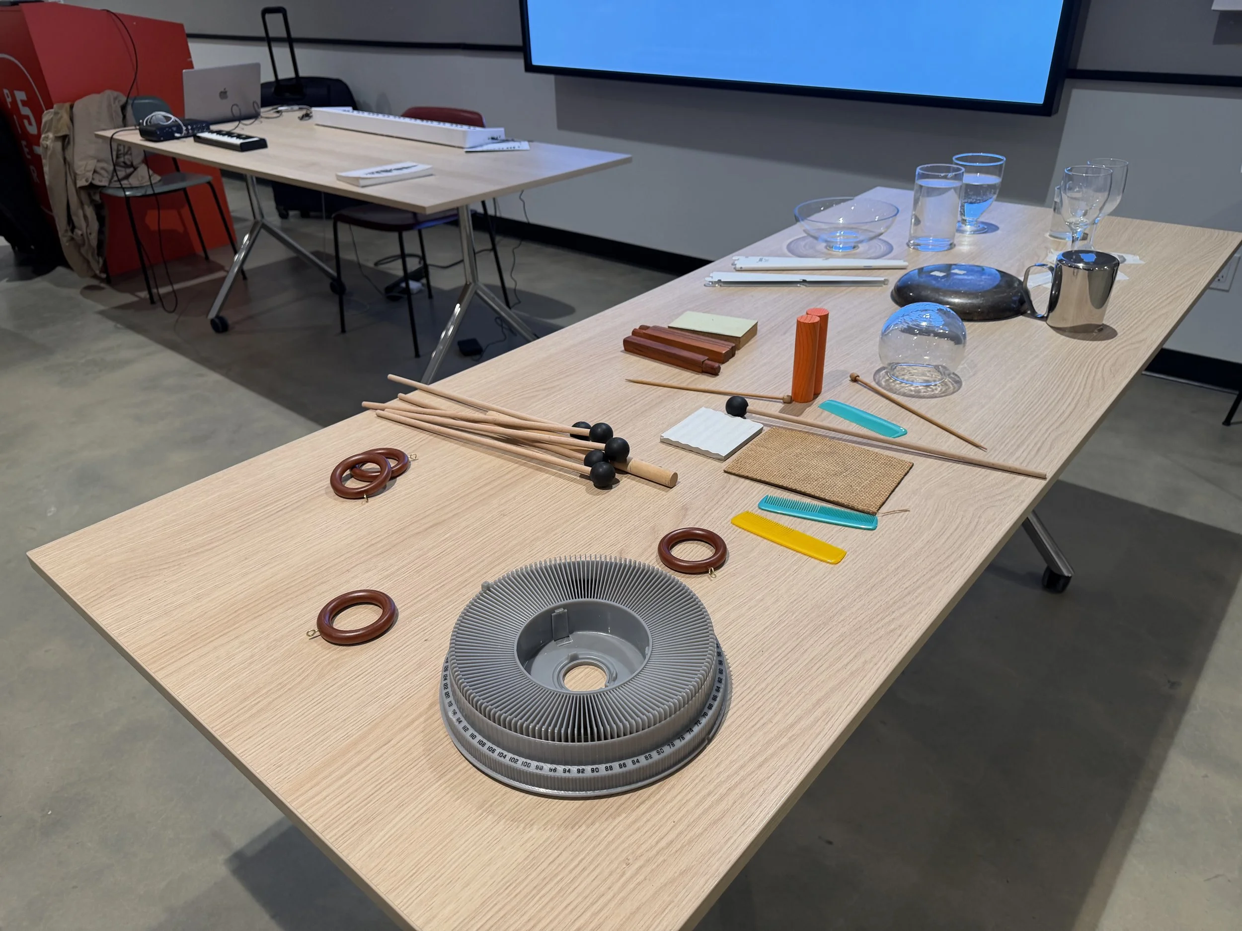 Table with a variety of different found percussion instruments.  