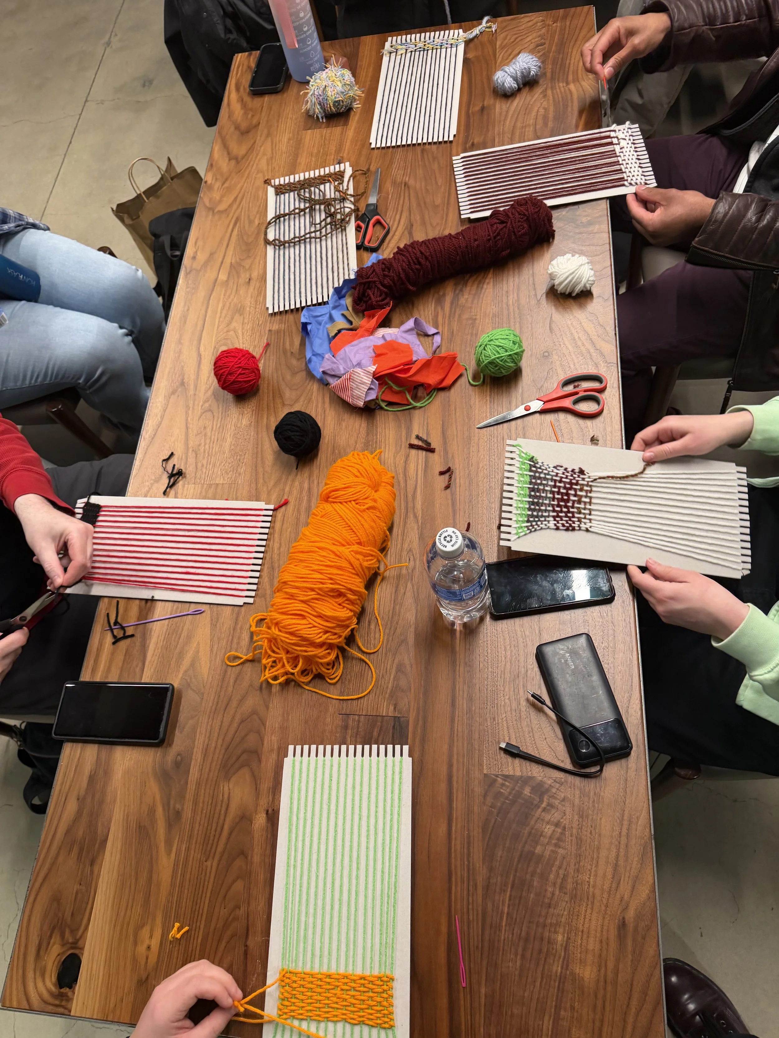  Table shot of attendees weaving. 