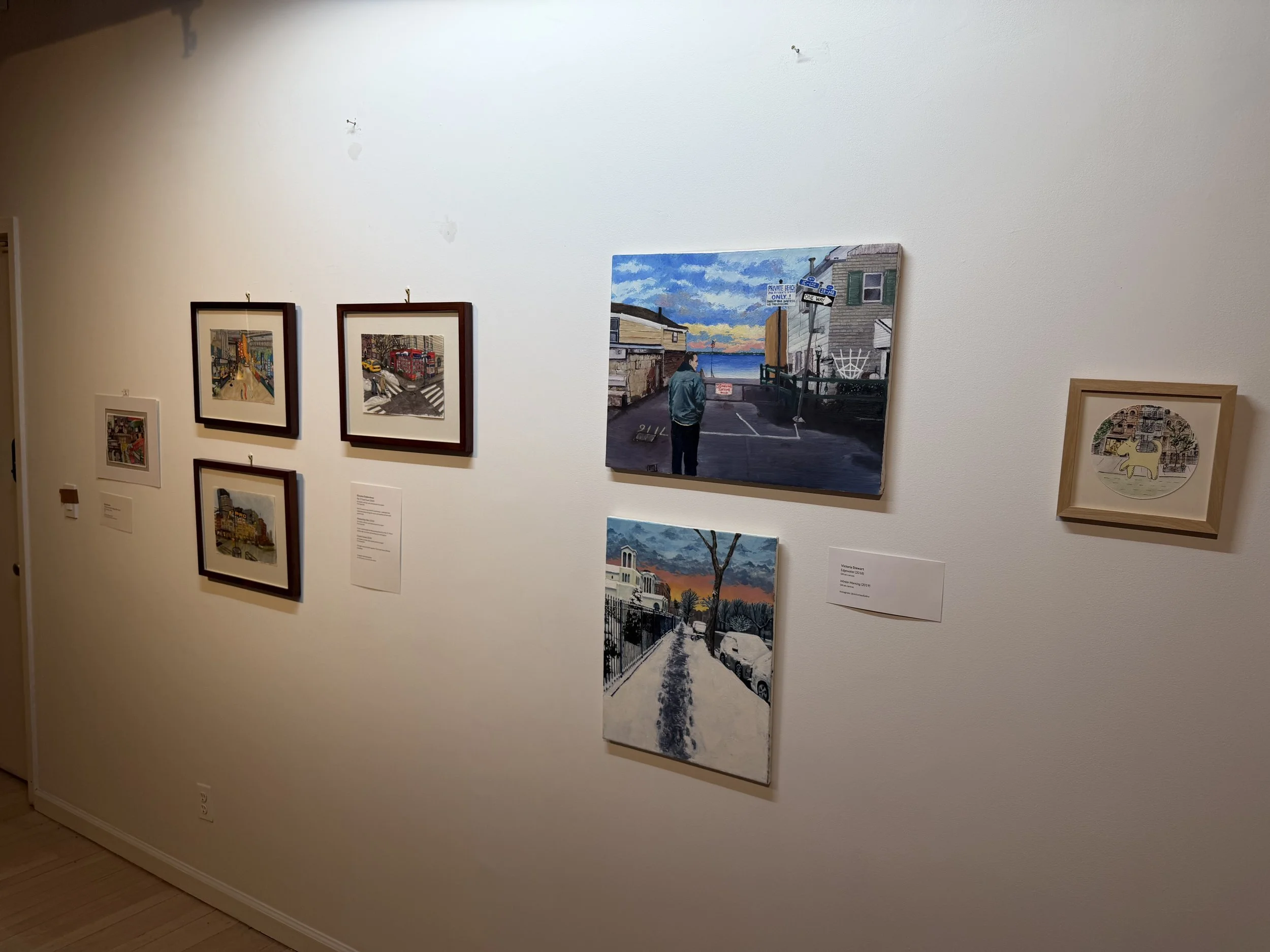  Image of gallery wall showing various artworks depicting NYC and NJ scenery. 
