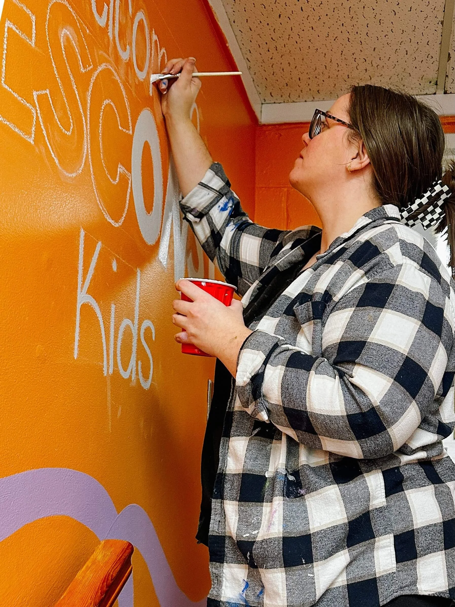 Paxton painting a mural at Nesconset Christian Church for NCC Kids
