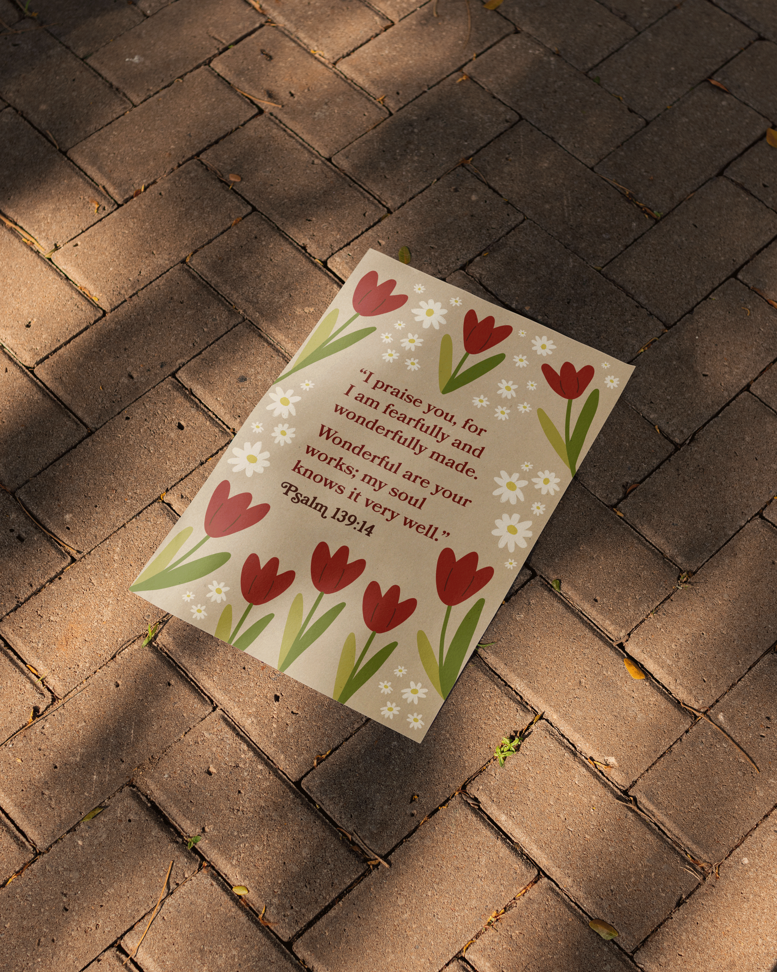 Poster Mockup on a brick sidewalk that reads "Psalm 139:14" with flowers illusrated