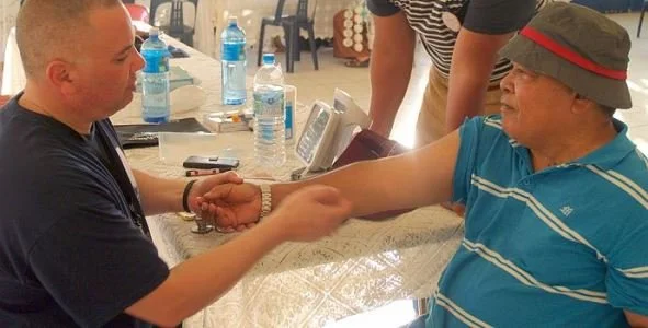 Dr Glenn Doherty assessing patient