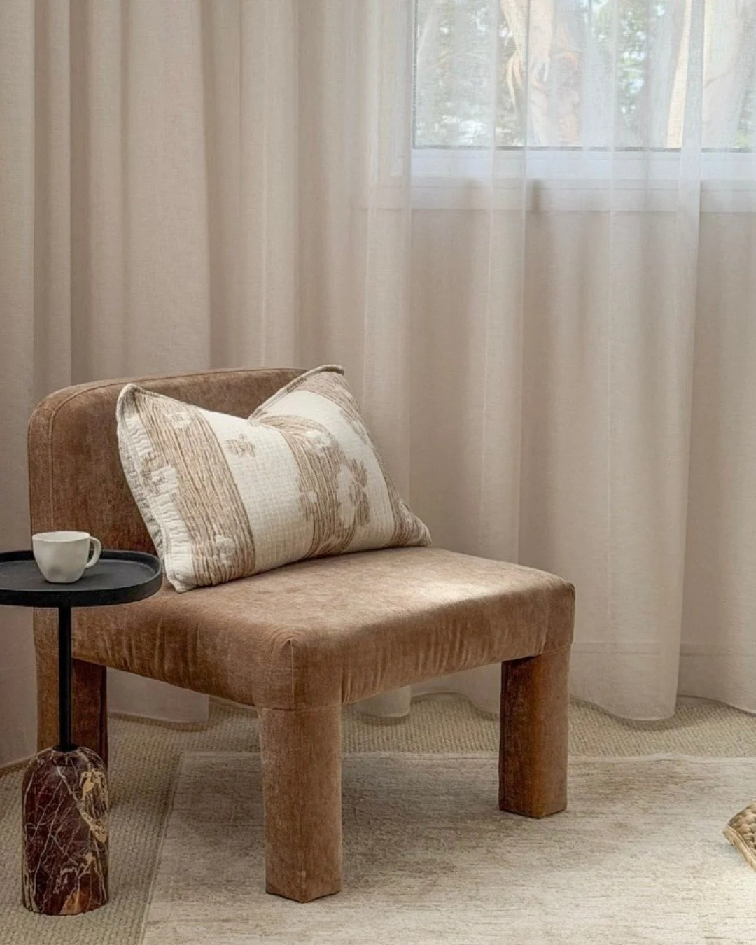 A master bedroom layered with warmth, texture, and thoughtful styling details.