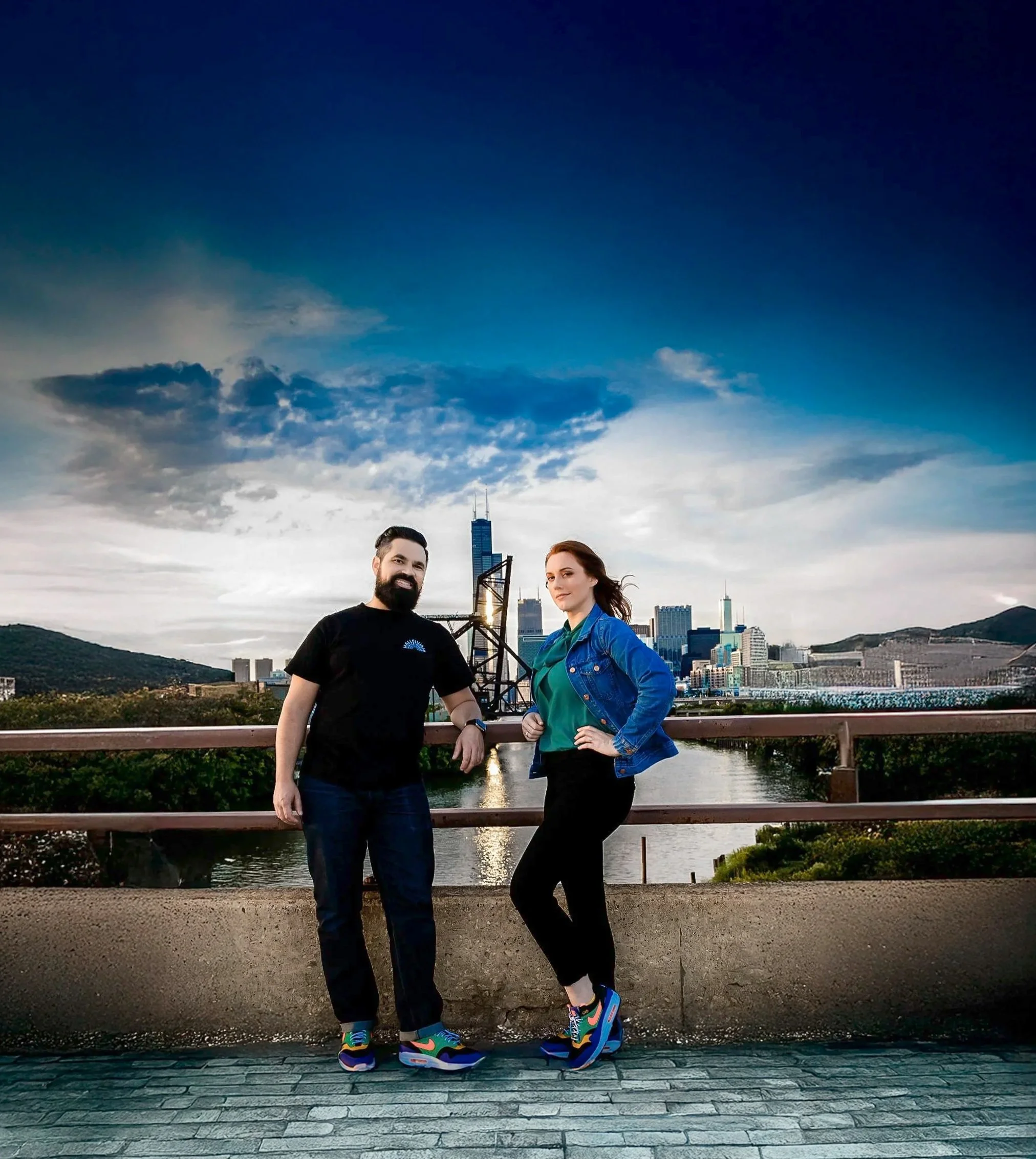 Romantic engagement photography near the historic 18th Street Bridge and Ping Tom Memorial Park in Chicago. A newly engaged couple poses along the South Branch of the Chicago River, with a historic railroad bridge and the dramatic downtown Chicago sk