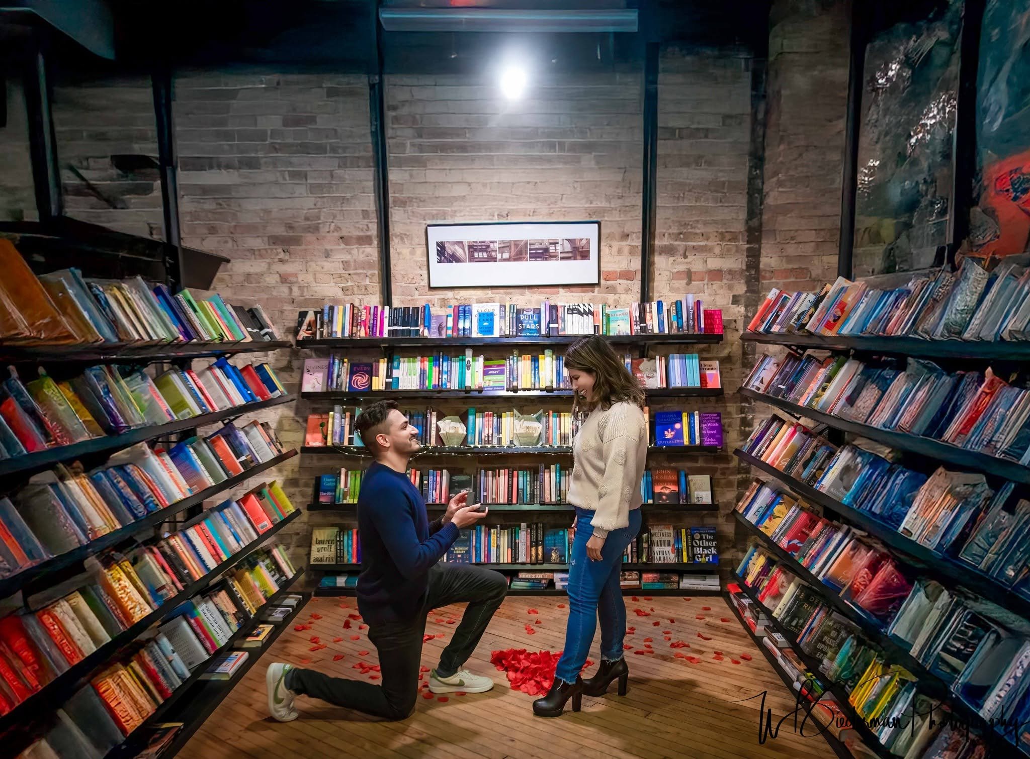 Love stories have many chapters, but this one begins with a proposal! 📚💍 Surrounded by colorful bookshelves in a cozy West Loop bookstore, this couple shared an unforgettable surprise engagement in the heart of Chicago. A picture-perfect setting fo