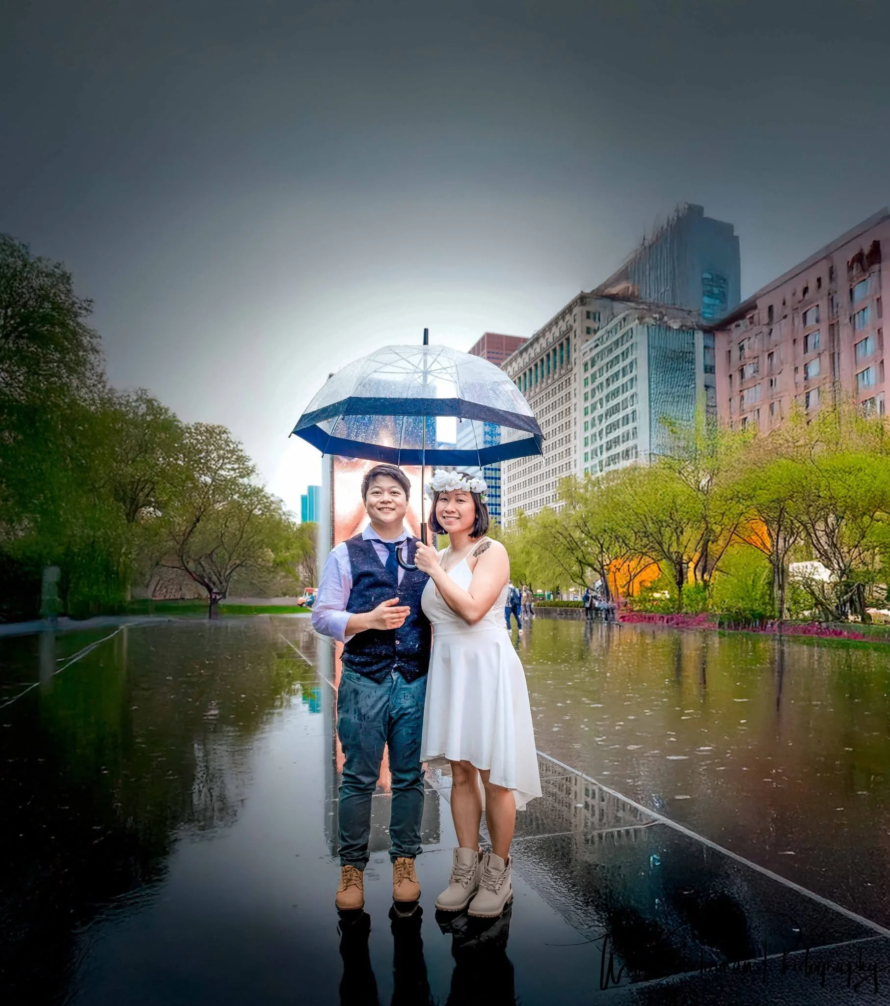 A little rain couldn't dampen the romance of this Chicago wedding! ☔💍❤️ Newly married and celebrating beneath an umbrella, this beautiful couple makes the most of a rainy day at the iconic Crown Fountain in Millennium Park.

Standing on the fountain