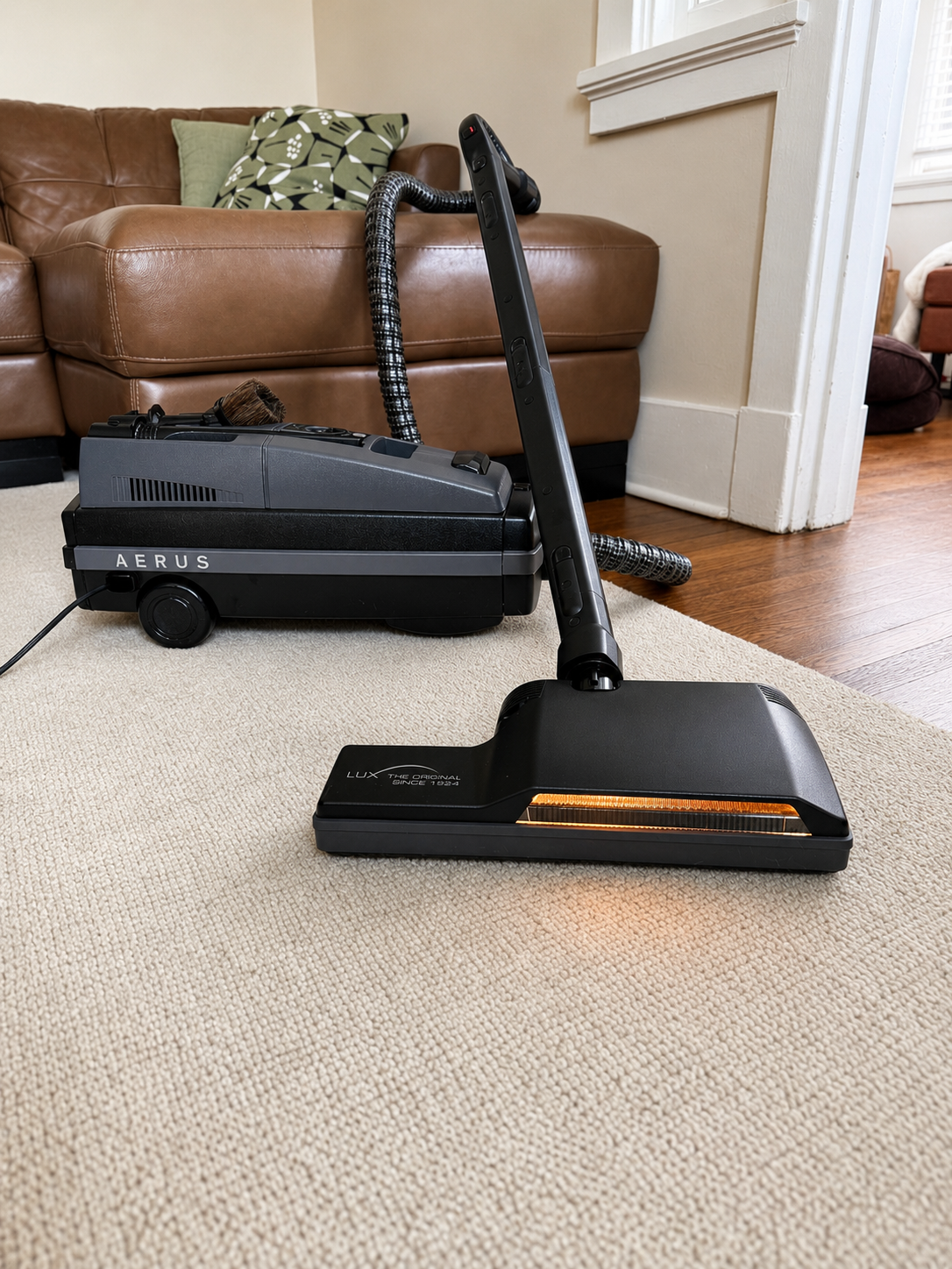 Shot of Aerus Legacy Deluxe Canister Vacuum with lighted powerhead, direct connect hose/wands and full sized attachment set.