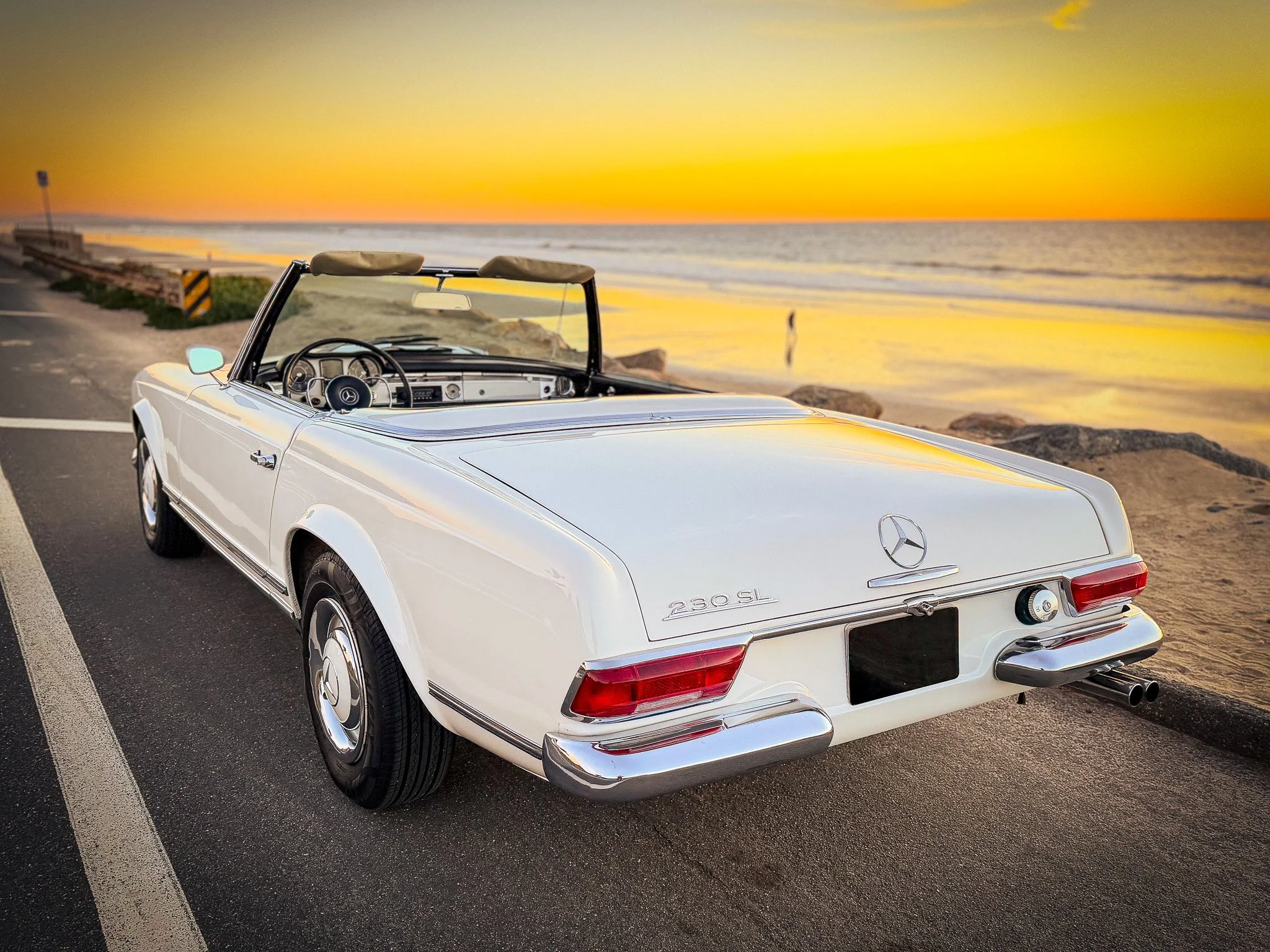 A white vintage Mercedes-Benz 230SL