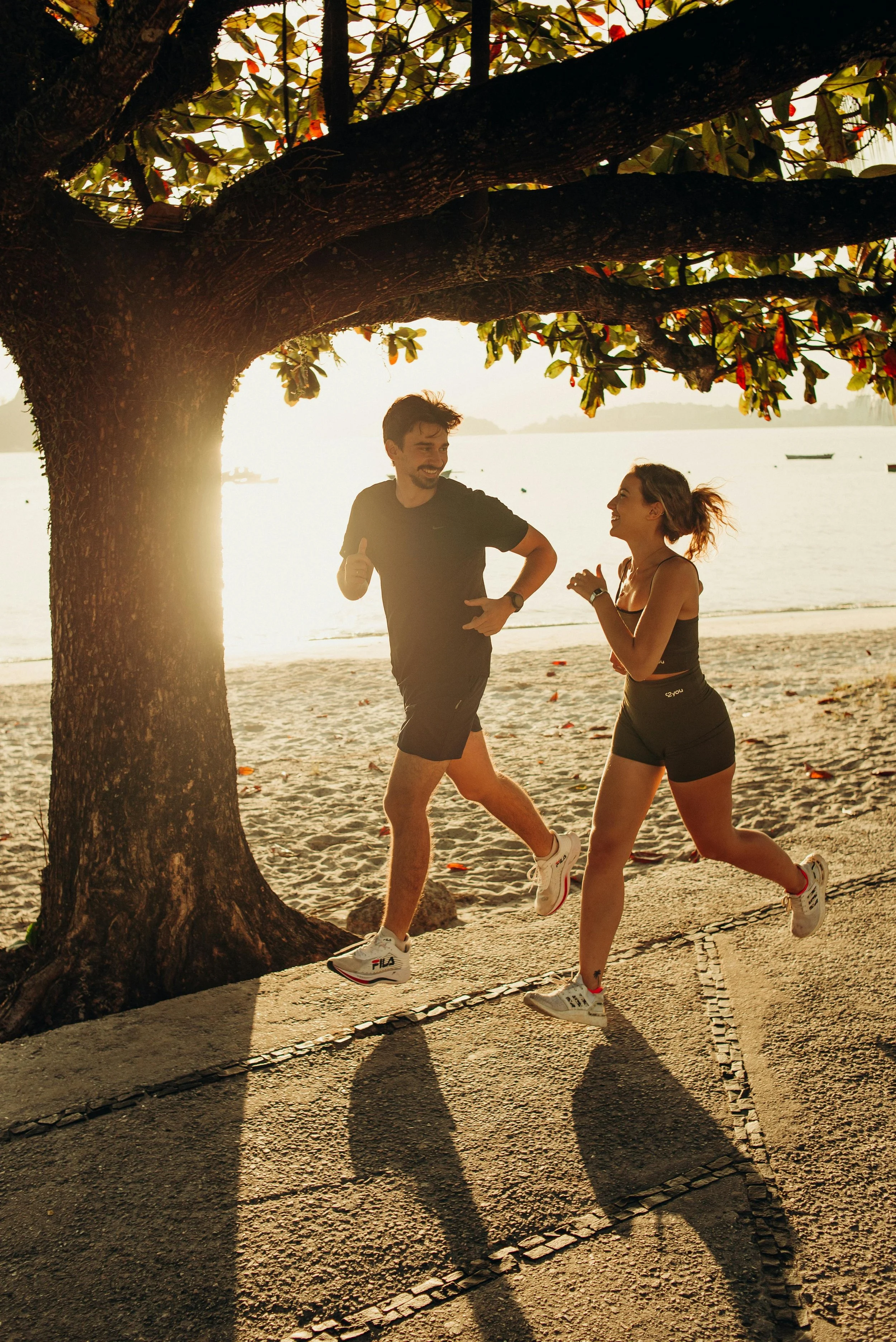 2 People Running with a beautiful view of a Rio de Janeiro beach