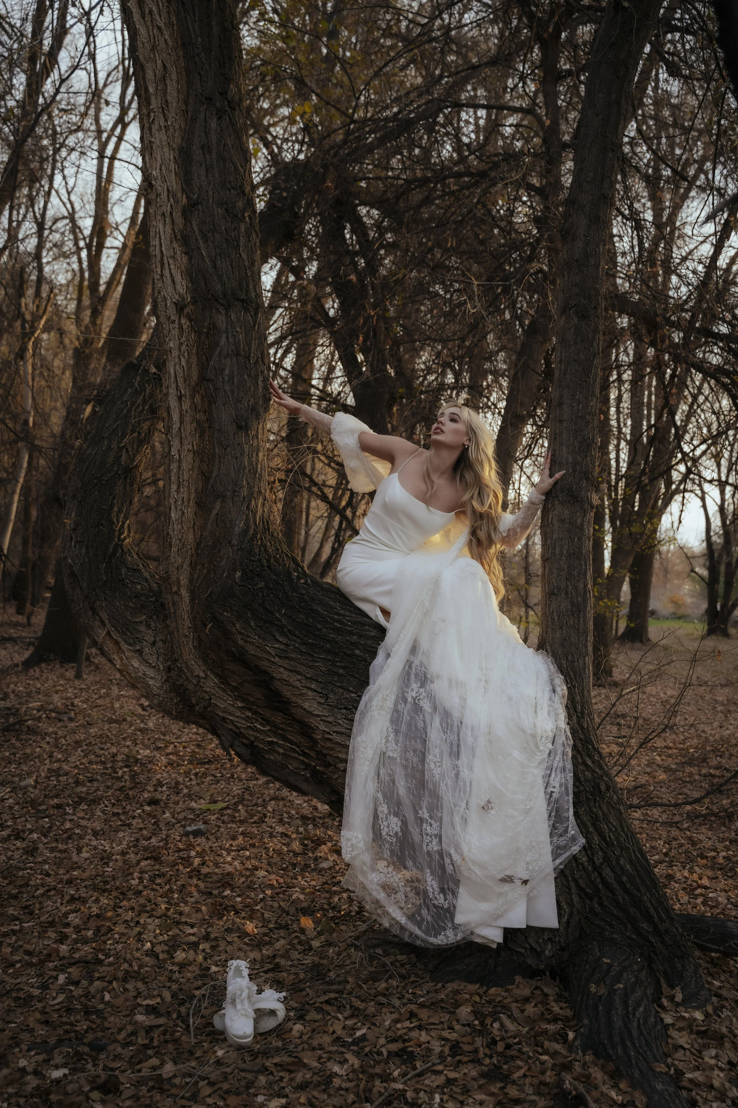 Gothic bridal session in Utah forest with long white wedding dress train