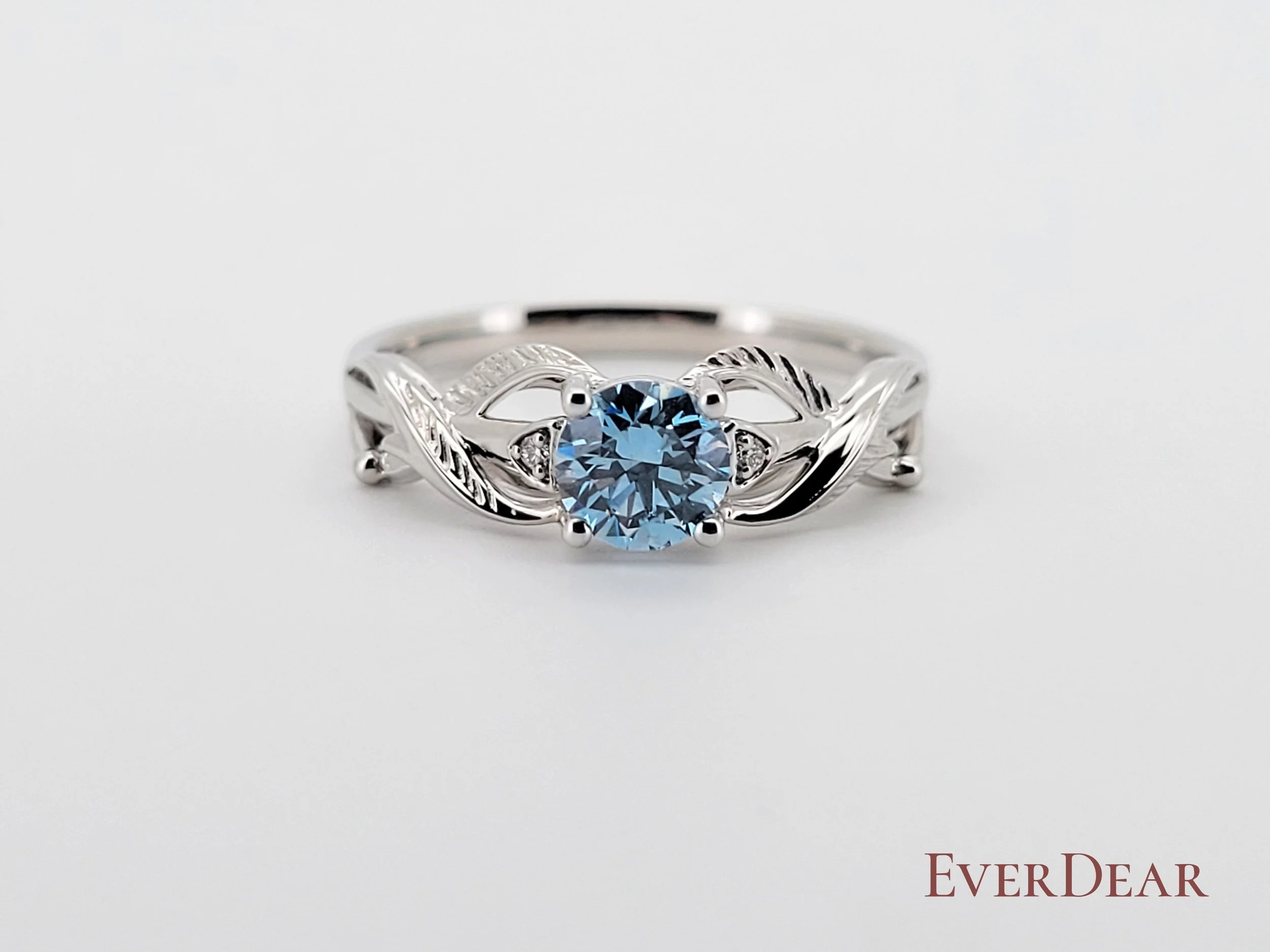 An intricate platinum cremation ring featuring a stunning blue diamond, with elegant twisted shank