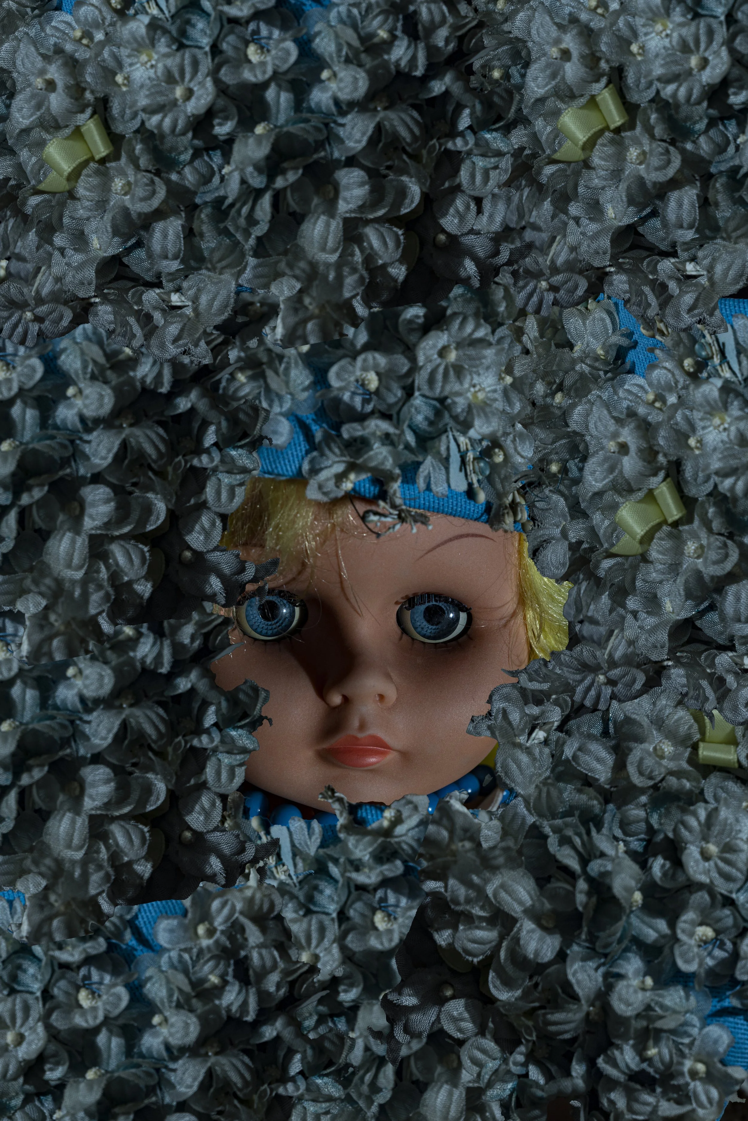 doll's head covered in blue flowers