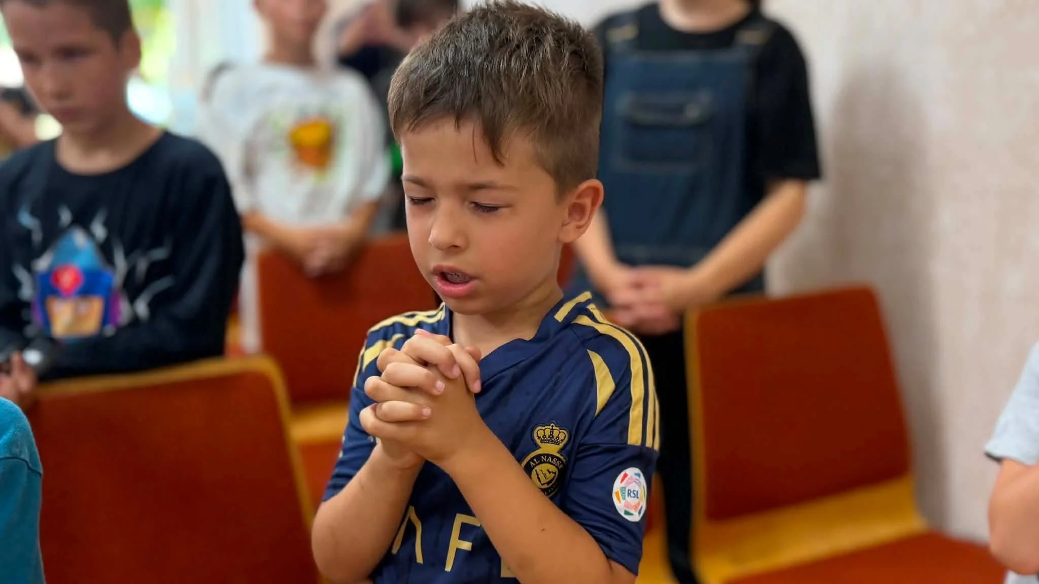 Child praying in Moldova