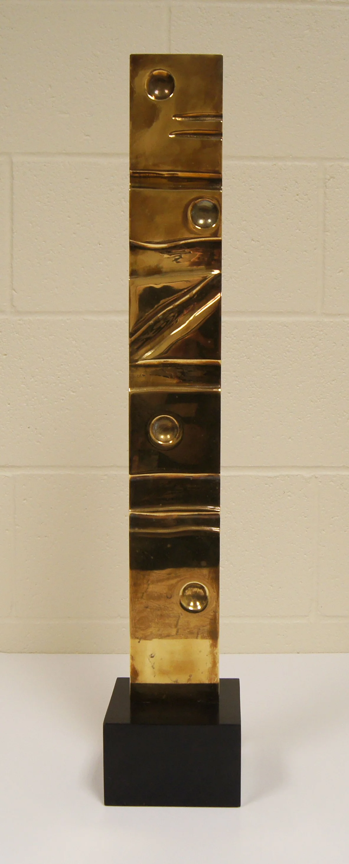 Joseph McDonnell (American 1936) “Stella IV Marquette”, 1983, brass, stone, gift of Jeff Parker, 1998 (27’’ H x 5’’ W x 5’’ D) 