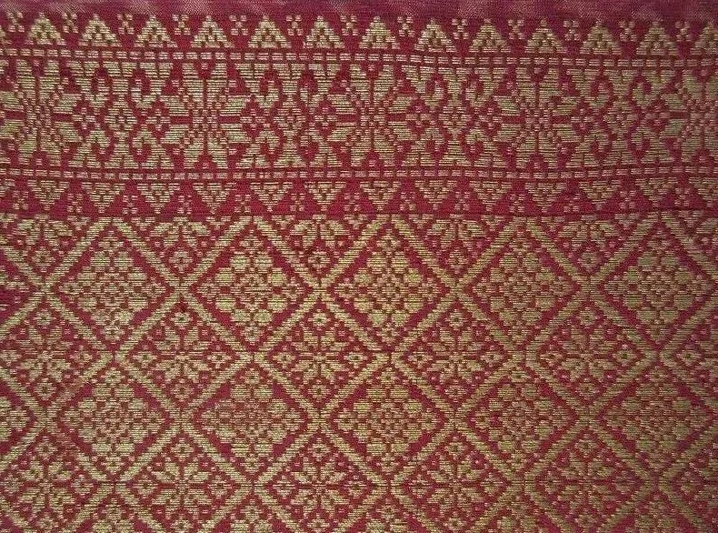 Malaysia. Palembang Songket Head Cloth. Pre 1920. Weft ikat, supplementary weft weave, silk and gold thread with natural dye. Dimensions 83.8 cm x 114 cm. The red ground of the cloth with resist dye floral medallions and gold thread rosettes, bordere