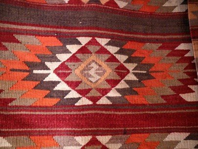 Jordan. Detail of Bedouin rug with tribe crest in the centre. Goat wool. Rightsof Paths of Jordan. Accessed via https://www.pathsofjordan.net/weaving