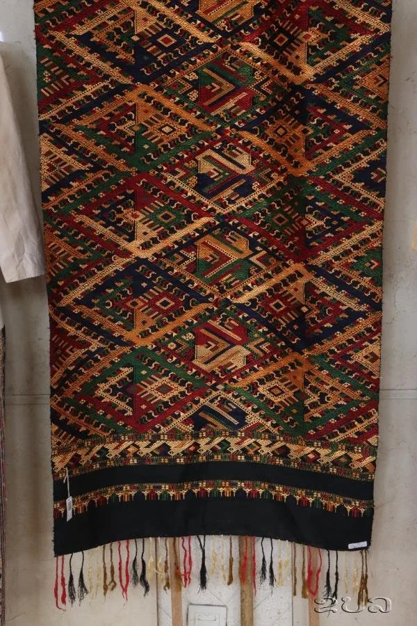 Laos. Naga pattern on silk cloth. Starting from the age of 10, Lao girls begin to learn weaving from their mothers, grandmothers and mothers-in-law. This learning process is conducted through verbal communication and hands-on practice without textboo