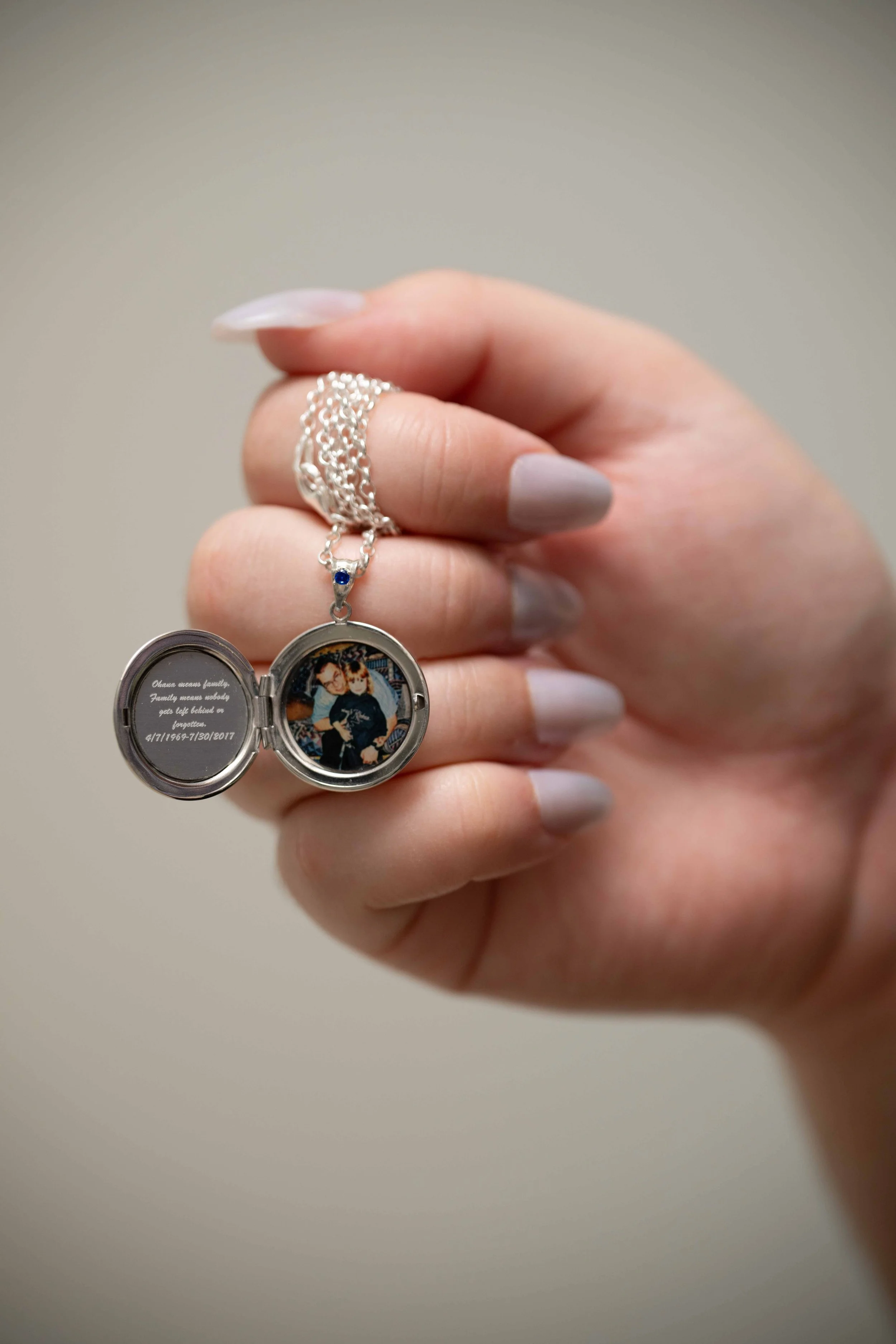 Holding locket open to see interior photo