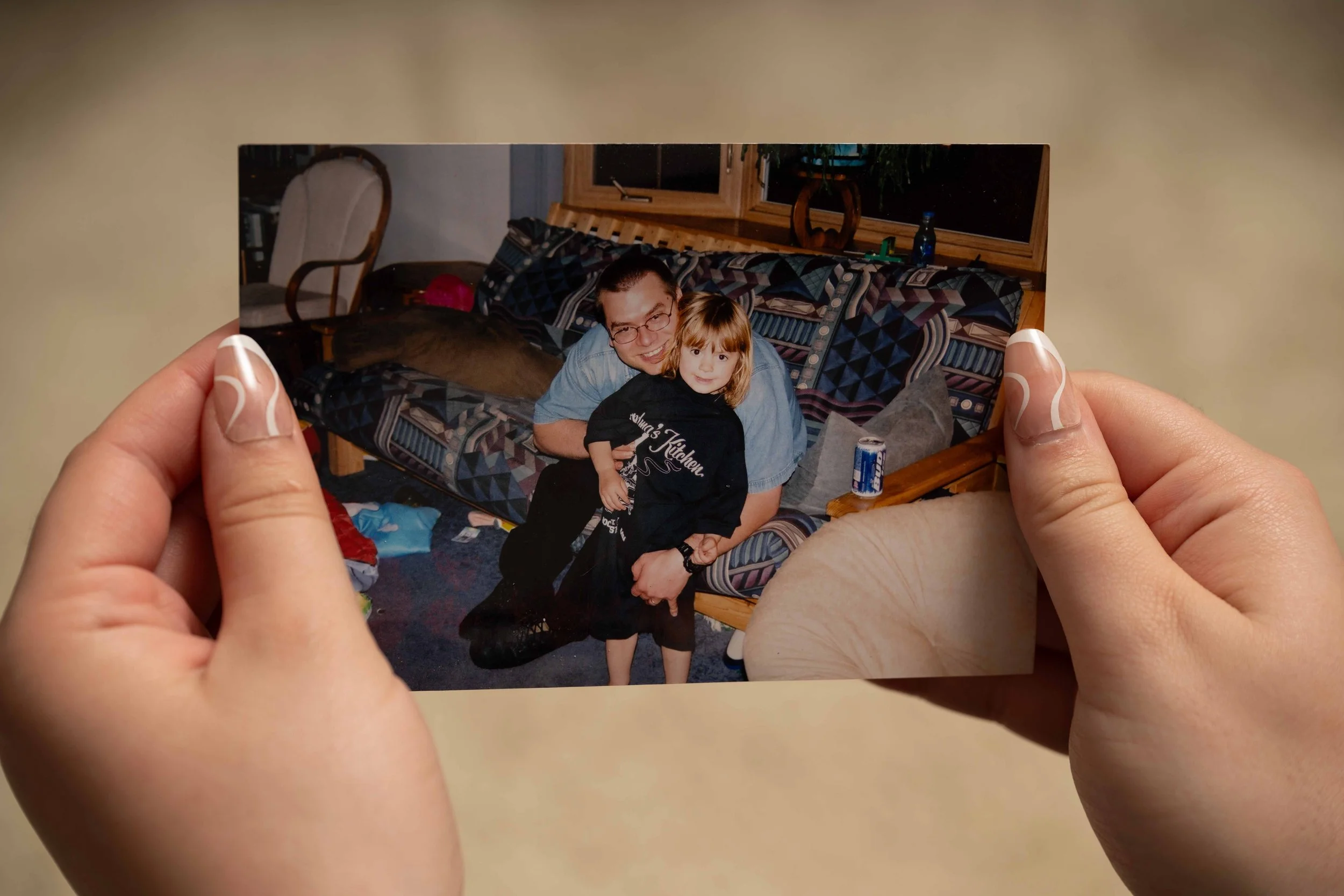holding a photo of my dad and I