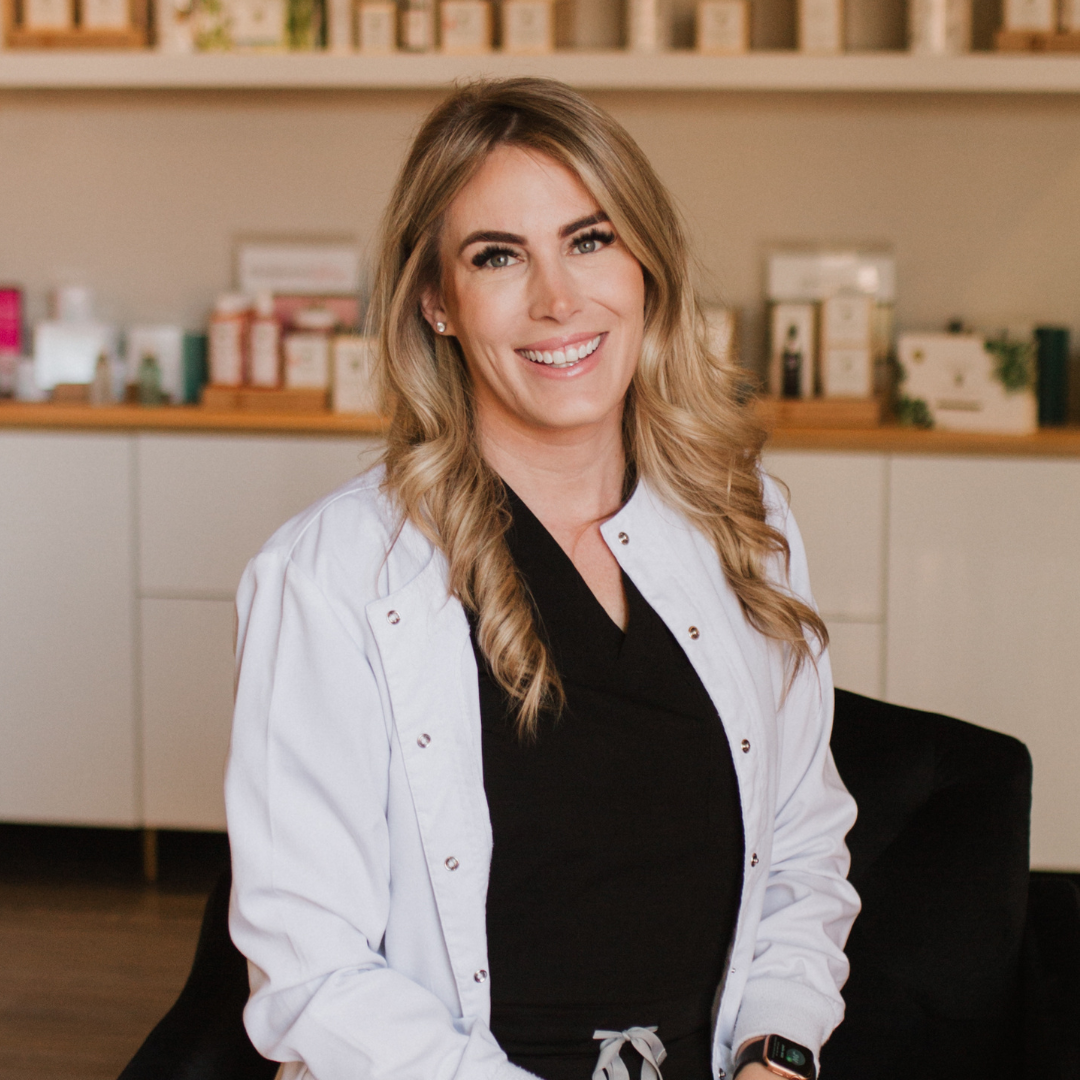 a professional nurse injector smiling while sitting