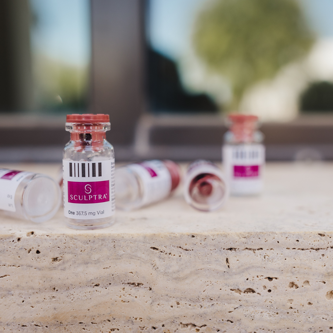 Sculptra collagen stimulator vials displayed on a stone countertop