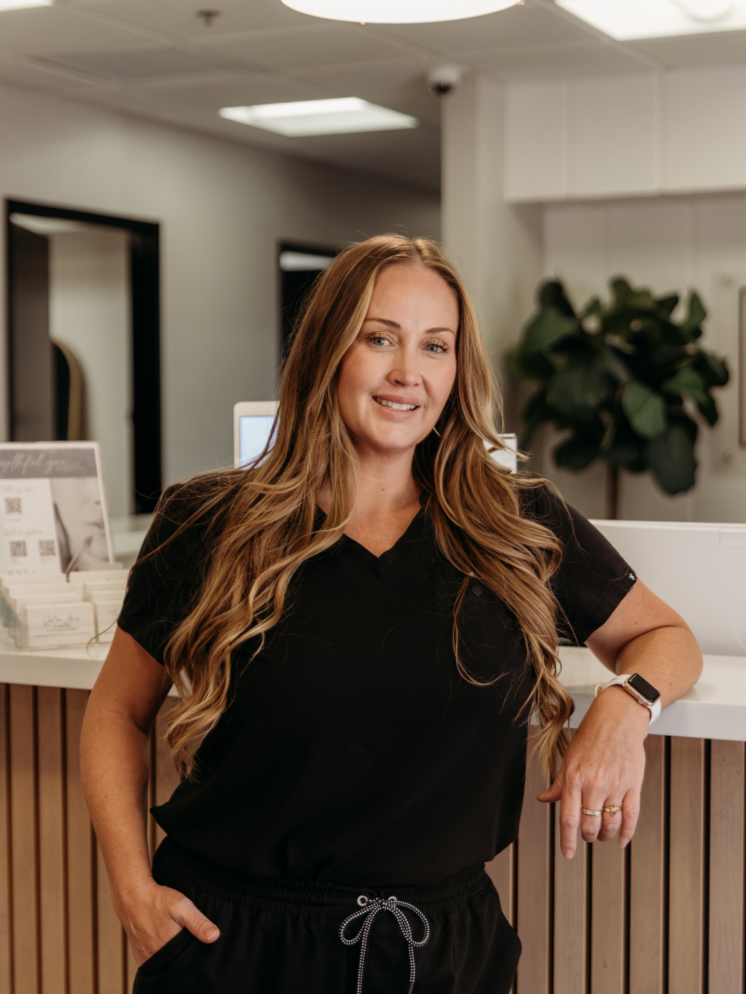 professional woman standing at the front desk of her office