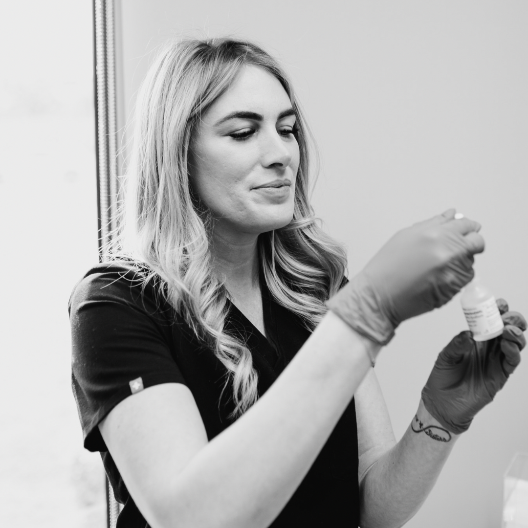 a professional woman prepping her needle for cometic injections