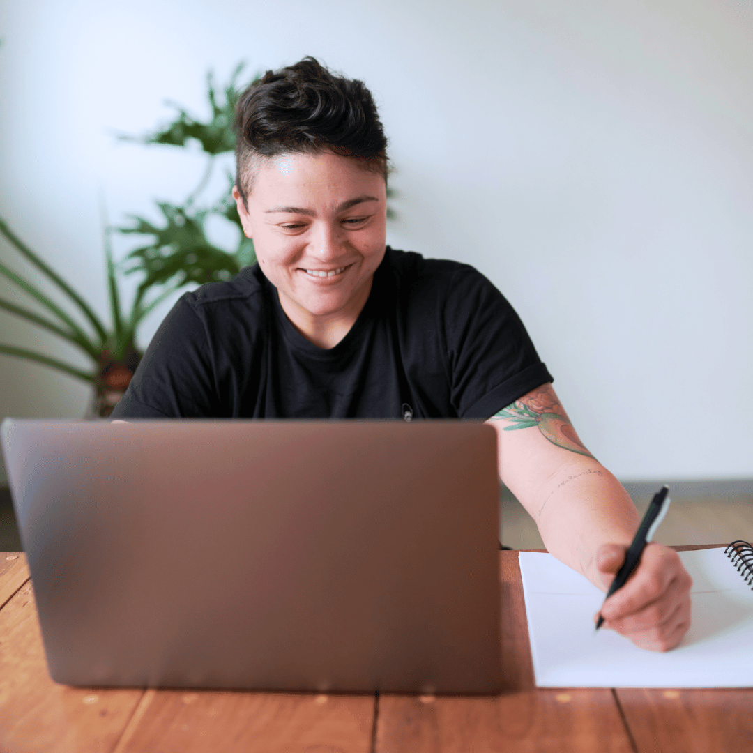 Woman working for a charity using GoodCRM software taking helpful notes on a training call