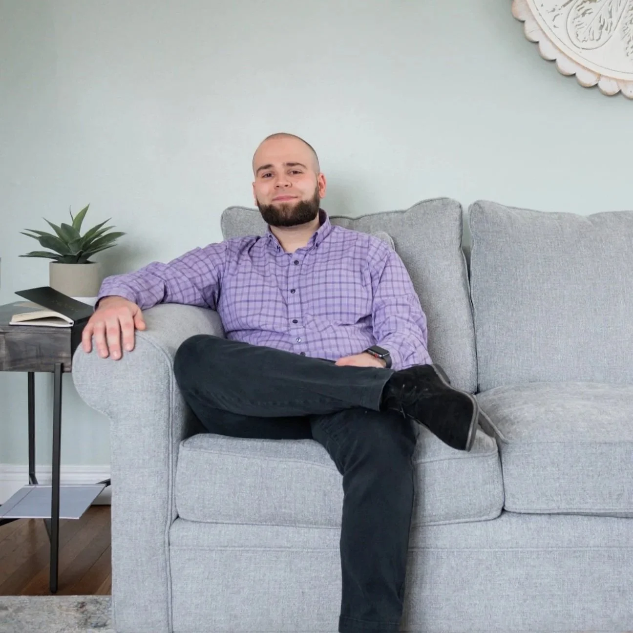 Therapist sitting on a chair in an office space, representing professional support available through online therapy for anxiety in Bay Shore, NY.