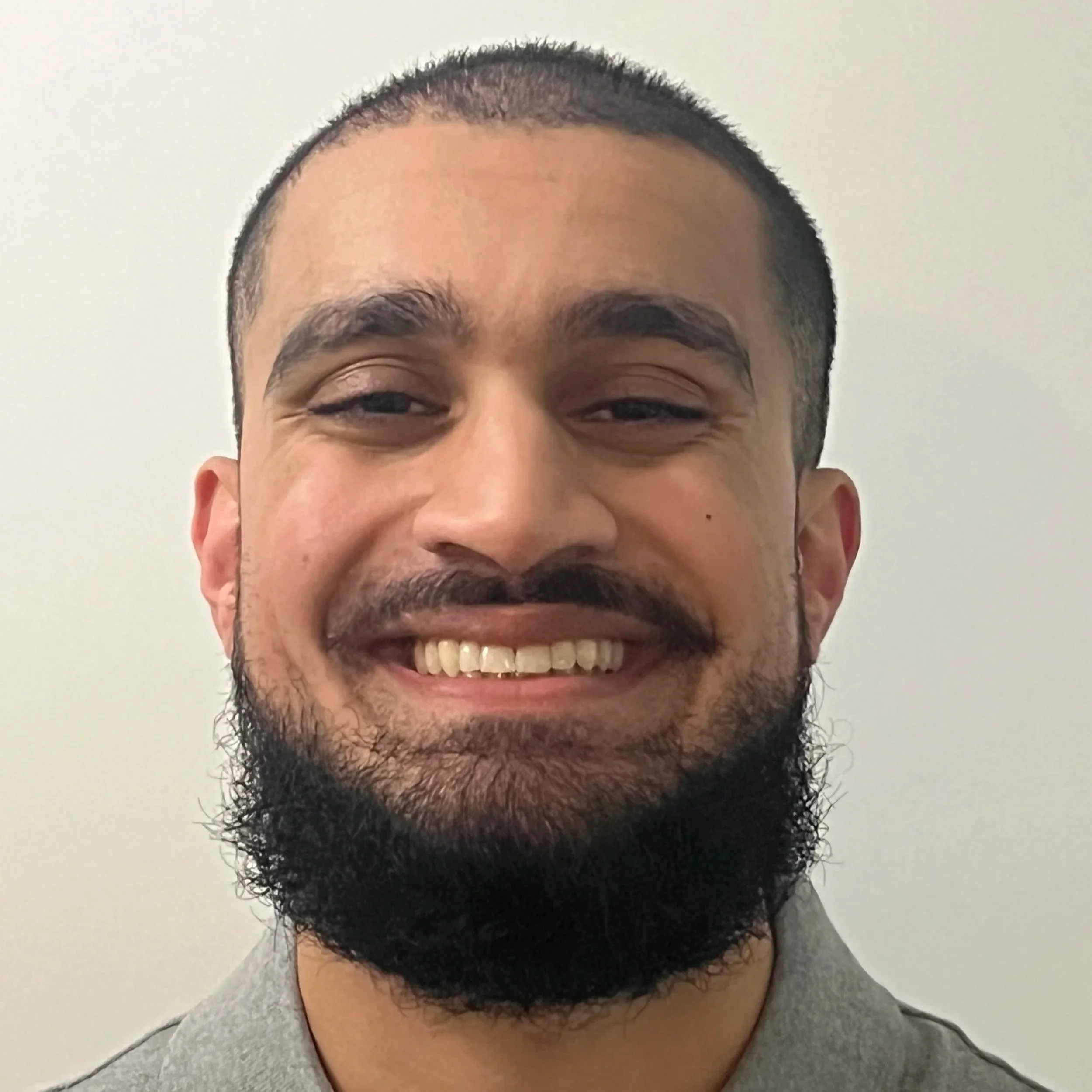 Shabib Afzal, smiling warmly, representing compassionate support and guidance through therapy in Bay Shore, NY.