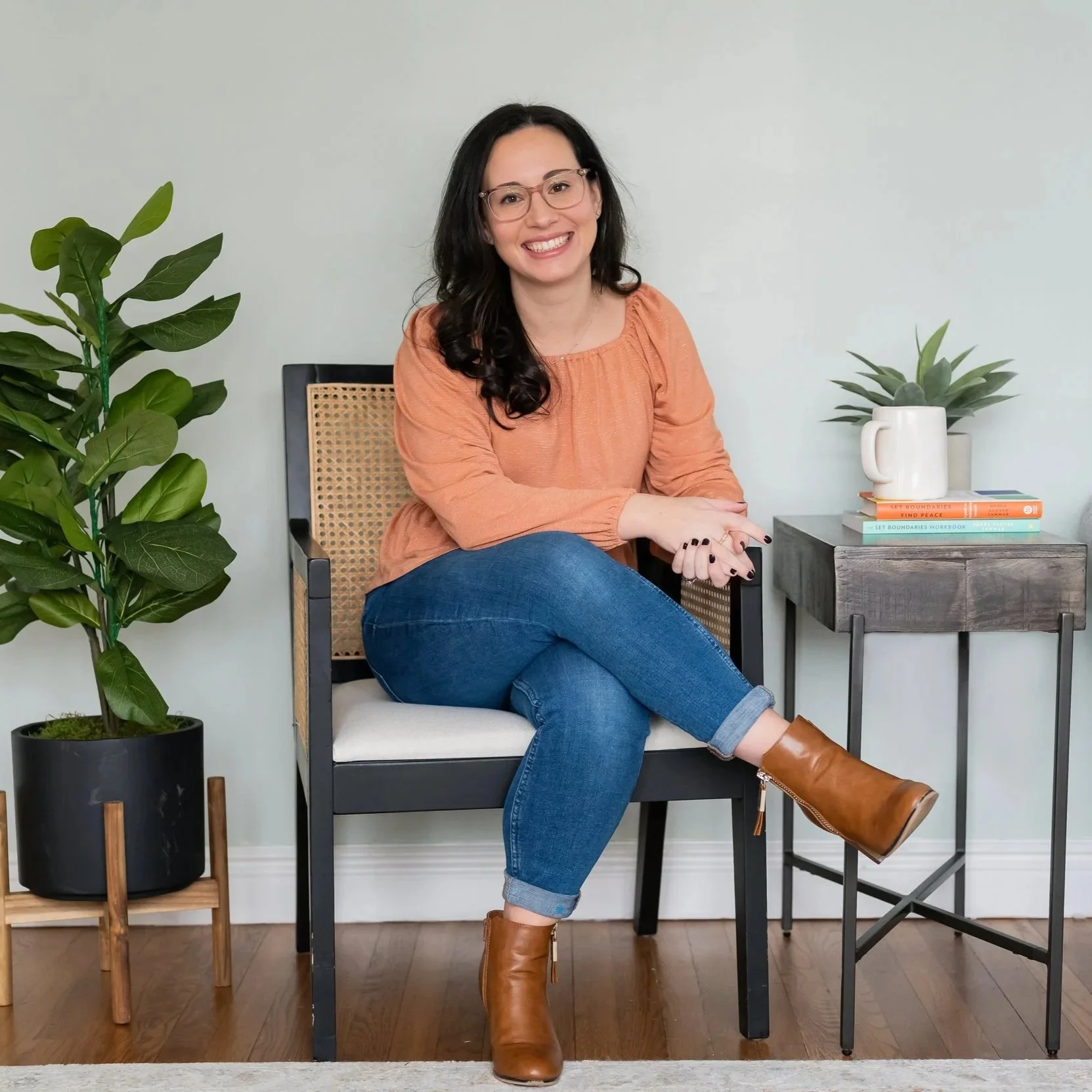 Kristen Belevich, therapist smiling while seated, representing a supportive and welcoming space for therapy for perfectionist women in Bay Shore, NY.