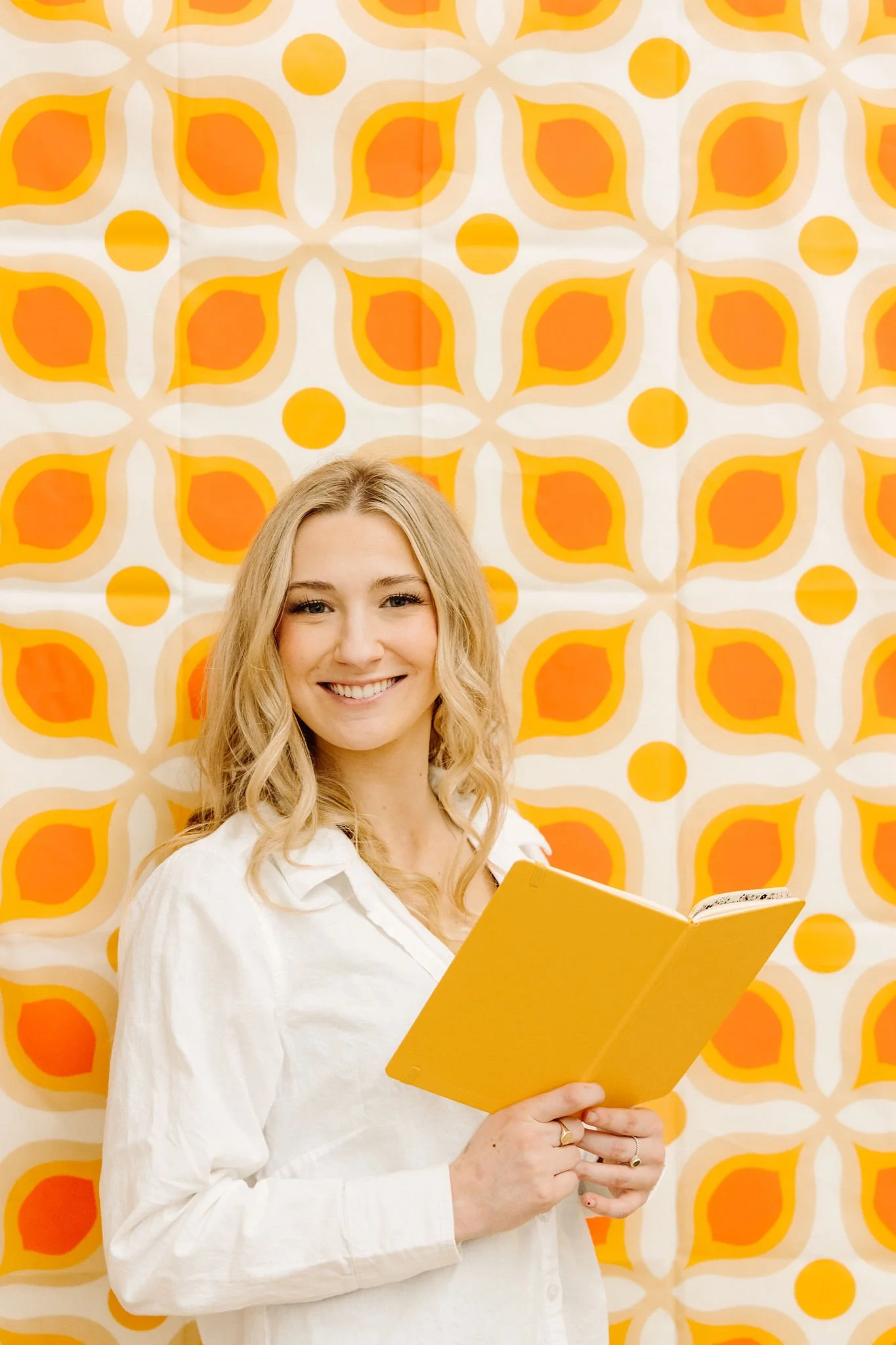 Frankie of Bare by Frankie smiling while holding a professional waxing product in her Lynden, WA studio