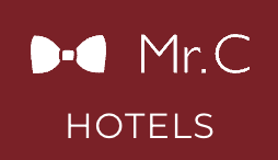 Logo for Mr. C Hotels featuring a white bowtie icon on a dark red background with white text.