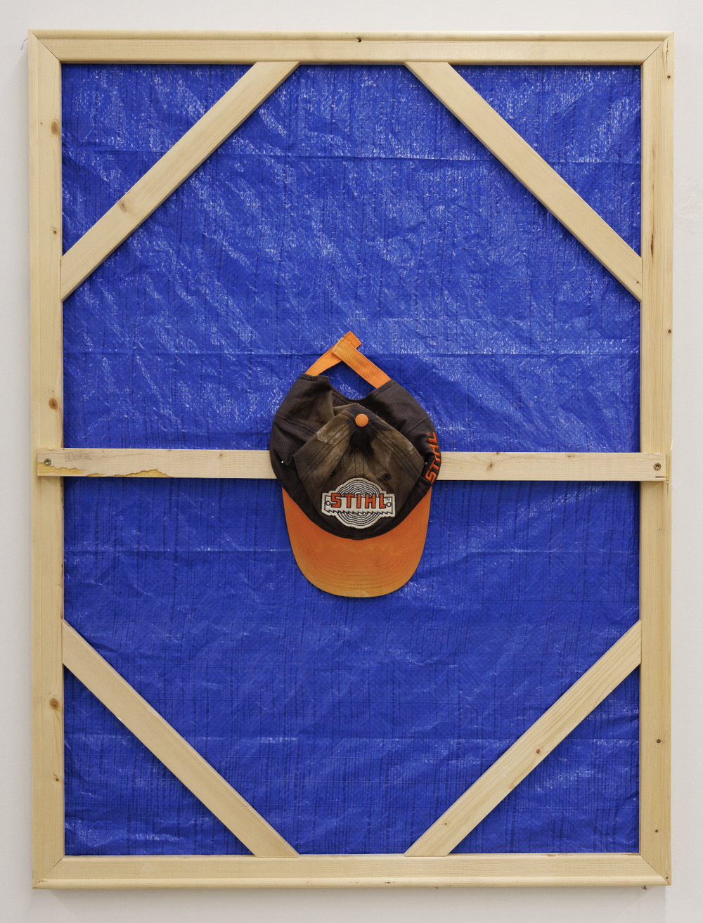 By the Sweat of Thy Brow (2025) tarp, found object, wood, and nails