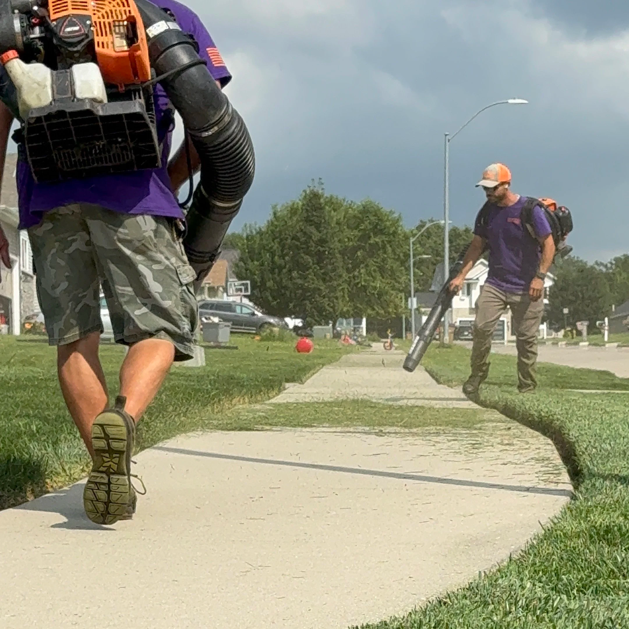 The Double Take Lawn Services crew doing a final blow off after a grass mowing service.