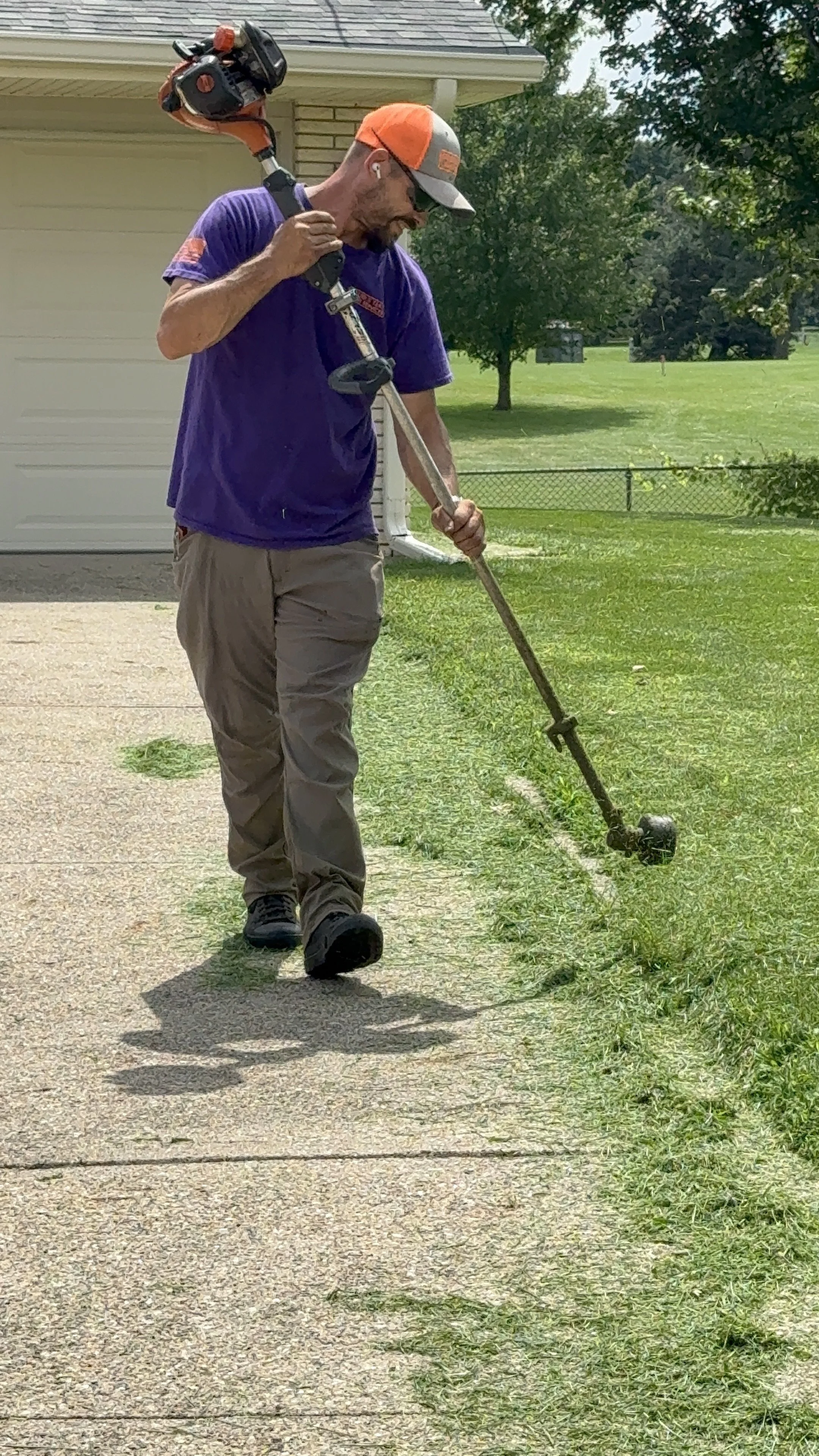 String trimming grass in East Des Moines, IA